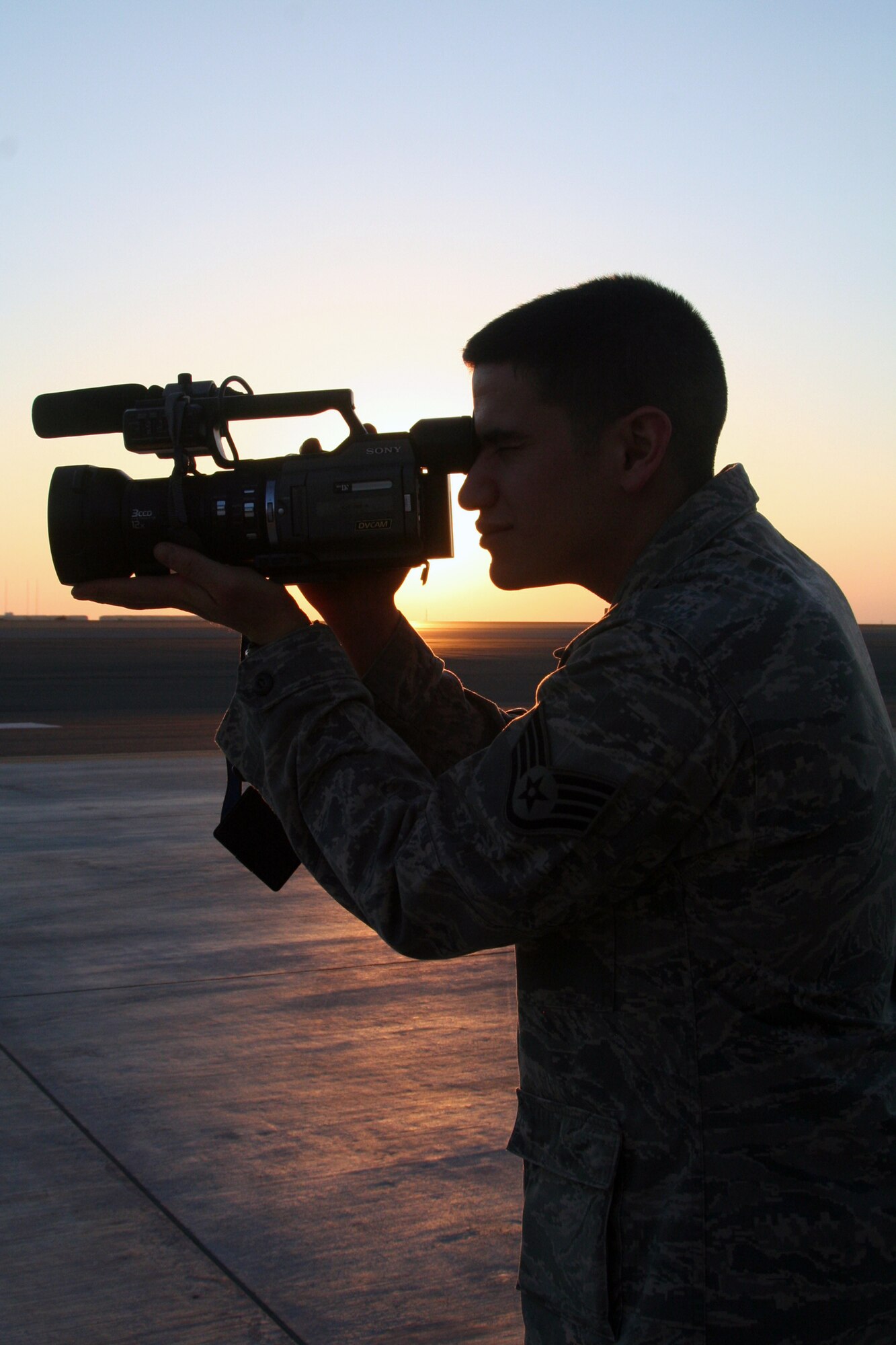 Staff Sgt. Nathan D. Delgado, a broadcaster assigned to the 380th Air Expeditionary Wing Public Affairs Office, takes documentation video of operations at a non-disclosed base in Southwest Asia on Dec. 30, 2009. The 380th AEW supports Operations Iraqi Freedom and Enduring Freedom and the Combined Joint Task Force-Horn of Africa. Sergeant Delgado is deployed from Elmendorf Air Force Base, Alaska, and his hometown is Blaine, Tenn. (U.S. Air Force Photo/Tech. Sgt. Scott T. Sturkol)