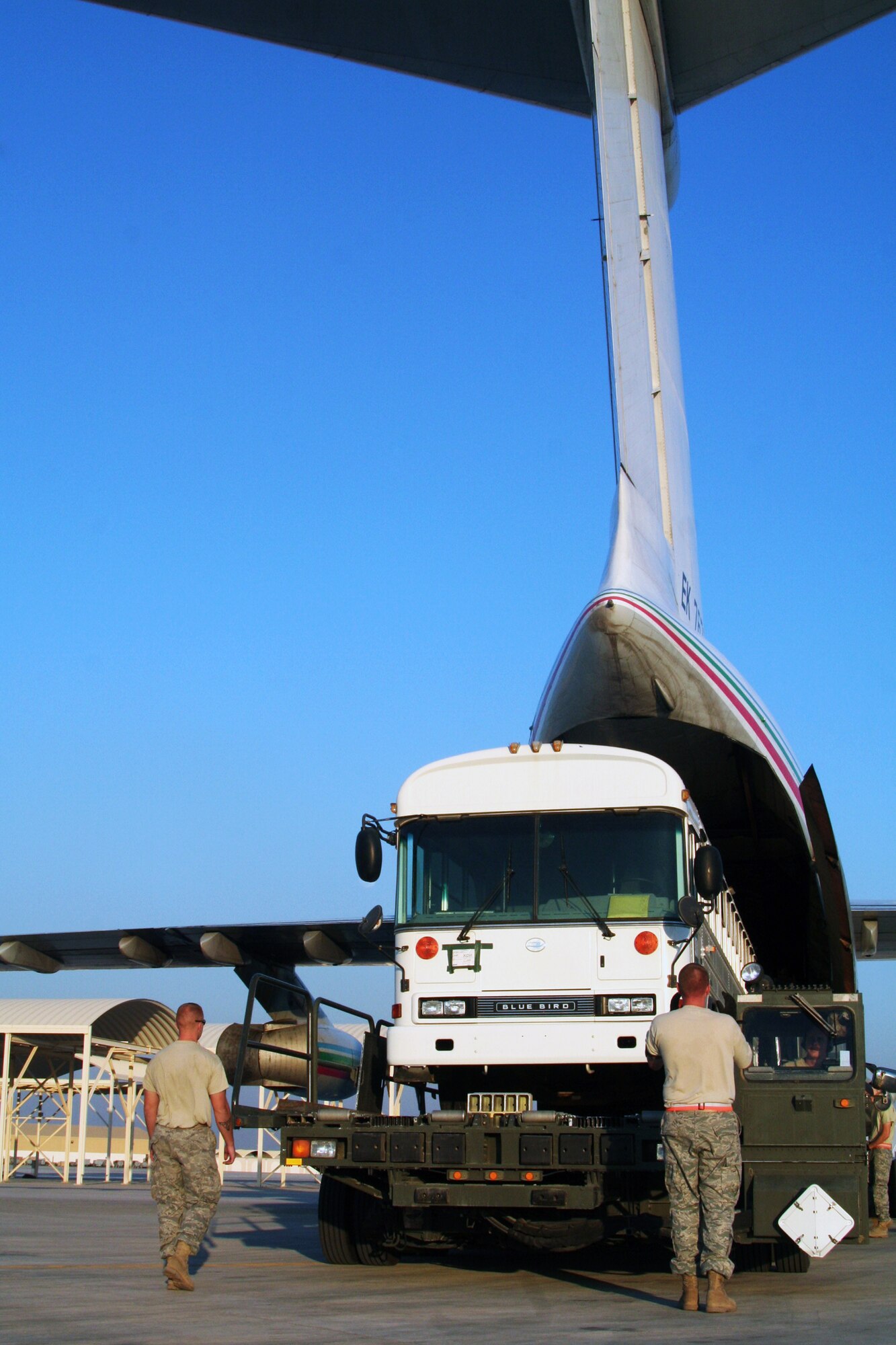 Air transportation Airmen assigned to the 380th Expeditionary Logistics Readiness Squadron Air Terminal Operations Center load a 44-passenger bus weighing more than 20,000 pounds onto a Russian-built IL-76 transport plane during operations at a non-disclosed base in Southwest Asia on Dec. 30, 2009. The bus was one of two that were loaded on the IL-76 for transport to Afghanistan. The 380th Air Expeditionary Wing supports Operations Iraqi Freedom and Enduring Freedom and the Combined Joint Task Force-Horn of Africa.  (U.S. Air Force Photo/Tech. Sgt. Scott T. Sturkol)