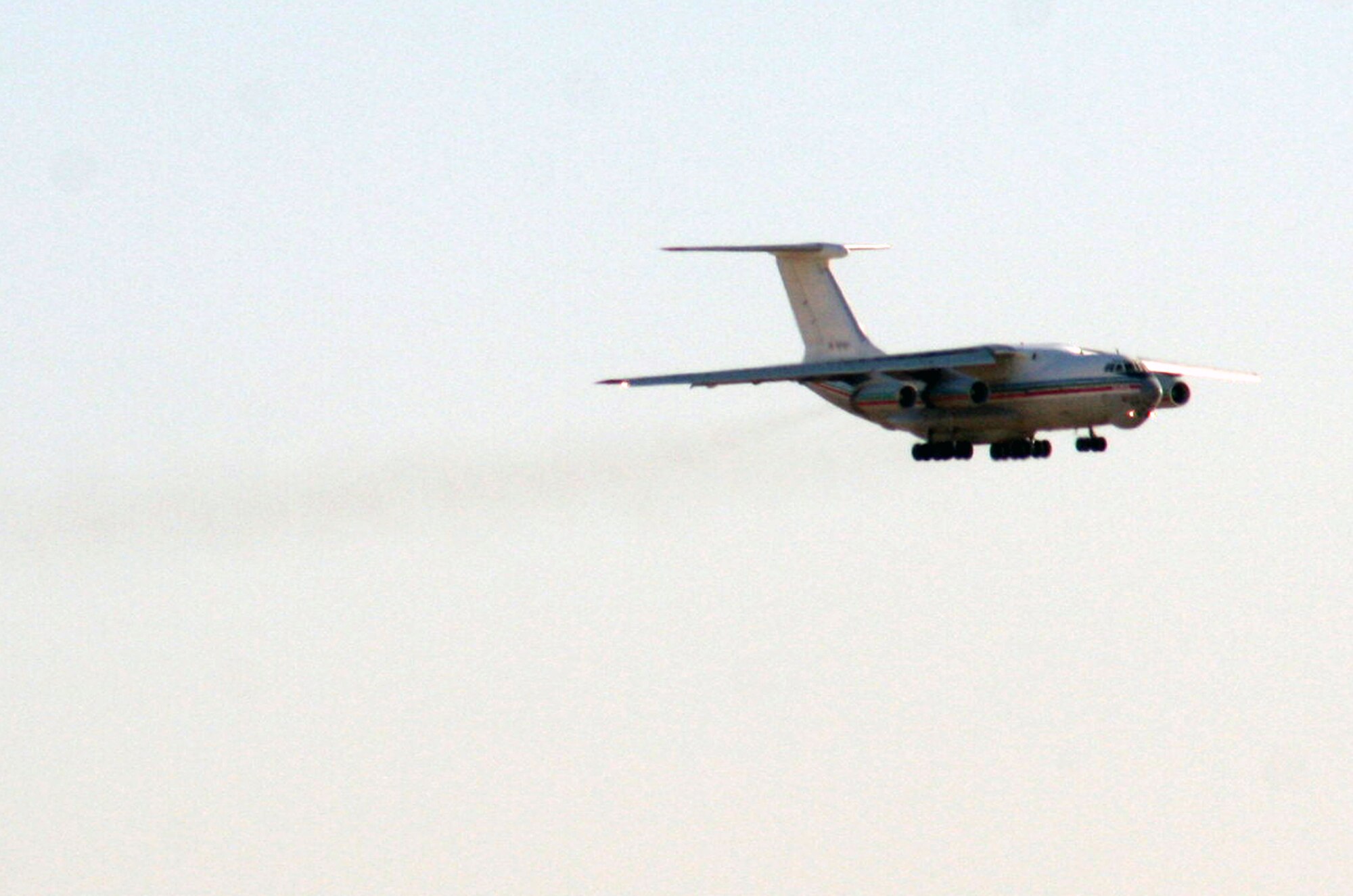 A Russian-built IL-76 transport plane comes in for a landing at a non-disclosed base in Southwest Asia on Dec. 30, 2009. The planed was loaded by air transportation Airmen assigned to the 380th Expeditionary Logistics Readiness Squadron Air Terminal Operations Center where they loaded two 44-passenger bus weighing more than 20,000 pounds each. The plane transported the buses to Afghanistan. The 380th ELRS and the 380th Air Expeditionary Wing support Operations Iraqi Freedom and Enduring Freedom and the Combined Joint Task Force-Horn of Africa.  (U.S. Air Force Photo/Tech. Sgt. Scott T. Sturkol)