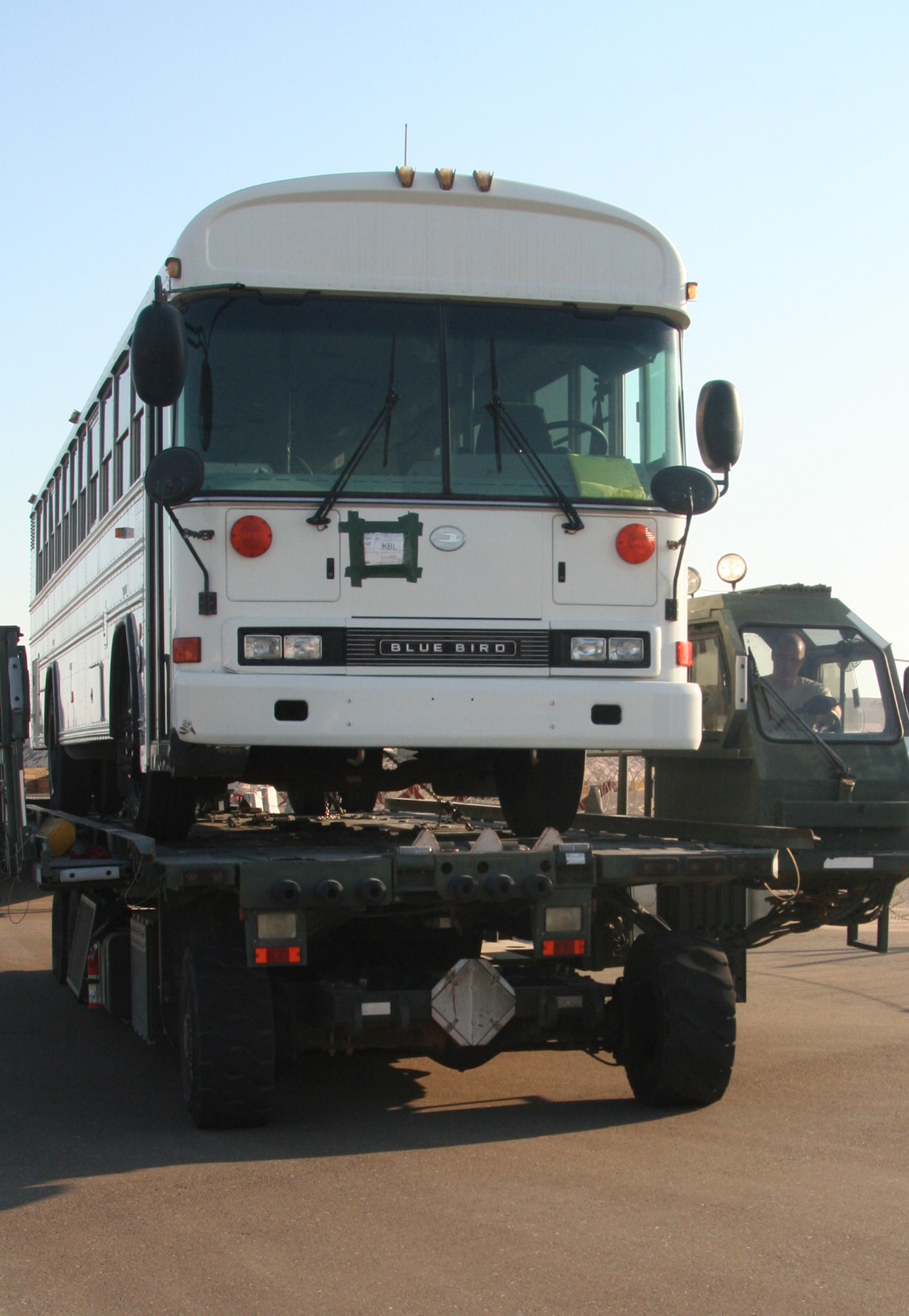 Tech. Sgt. Andrew McMahon, noncommissioned officer-in-charge of the 380th Expeditionary Logistics Readiness Squadron Air Terminal Operations Center, uses a loader to move a 20,000-pound bus in preparation to loading it on a Russian-built IL-76 transport at an non-disclosed location in Southwest Asia on Dec. 30, 2009.  Sergeant McMahon and five other air transportation Airmen loaded two of the buses on the transport which flew the buses to Afghanistan. Sergeant McMahon is deployed from the 89th Aerial Port Squadron at Andrews Air Force Base, Md., and his hometown is Van Wert, Ohio. (U.S. Air Force Photo/Tech. Sgt. Scott T. Sturkol)