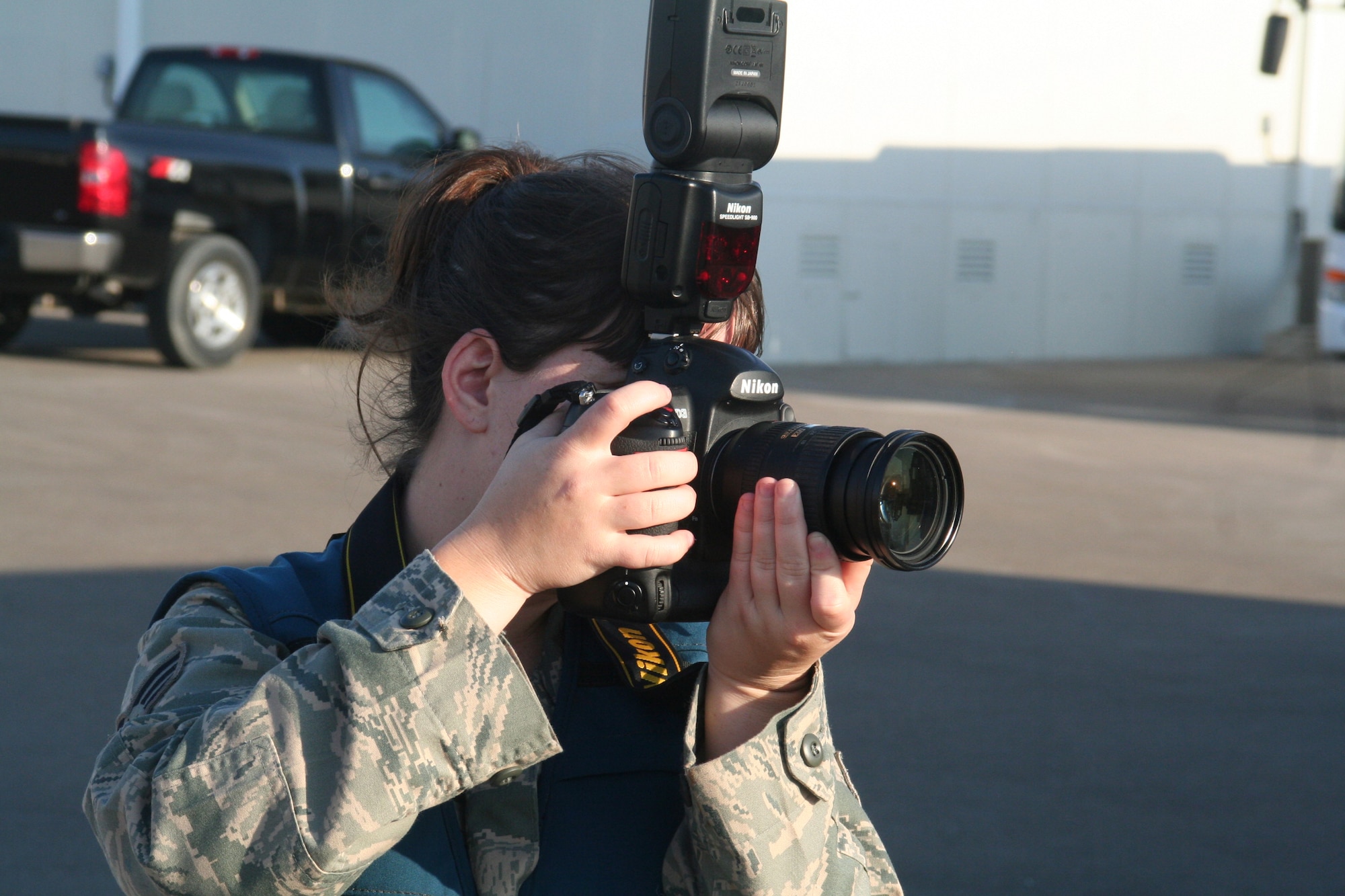 Senior Airman Jenifer H. Calhoun, a photographer assigned to the 380th Air Expeditionary Wing Public Affairs office, takes documentation photos of operations at a non-disclosed base in Southwest Asia on Dec. 30, 2009. The 380th AEW supports Operations Iraqi Freedom and Enduring Freedom and the Combined Joint Task Force-Horn of Africa. Airman Calhoun is deployed from Dyess Air Force Base, Texas, and her hometown is Little River Academy, Texas. (U.S. Air Force Photo/Tech. Sgt. Scott T. Sturkol)