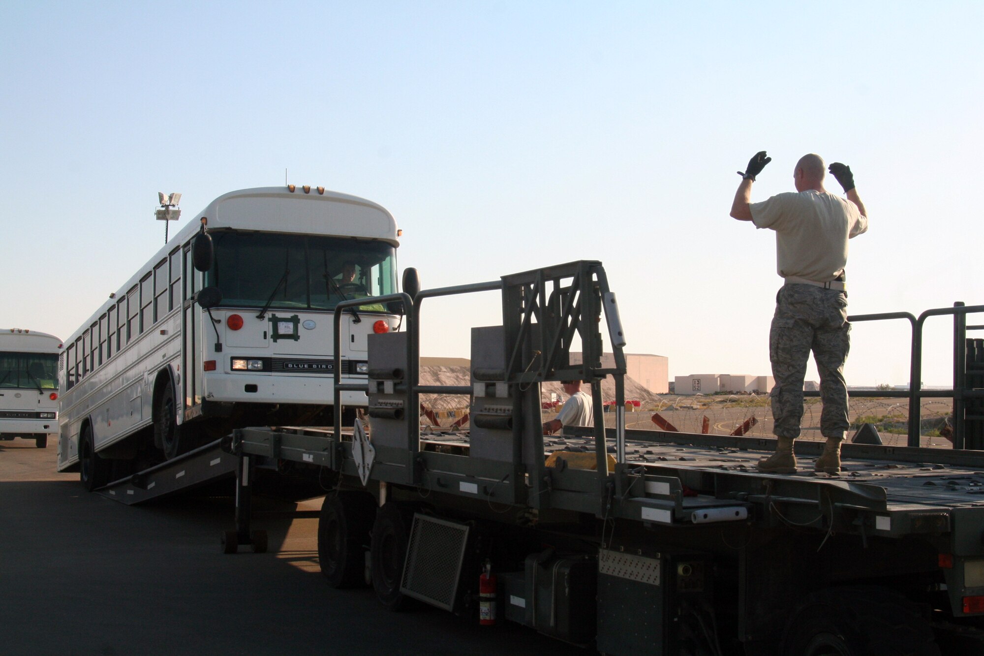 Air transportation Airmen assigned to the 380th Expeditionary Logistics Readiness Squadron Air Terminal Operations Center load a 44-passenger bus weighing more than 20,000 pounds onto a loader during operations at a non-disclosed base in Southwest Asia on Dec. 30, 2009. The bus was one of two that were loaded on a Russian-built IL-76 for transport to Afghanistan. The 380th Air Expeditionary Wing supports Operations Iraqi Freedom and Enduring Freedom and the Combined Joint Task Force-Horn of Africa.  (U.S. Air Force Photo/Tech. Sgt. Scott T. Sturkol)