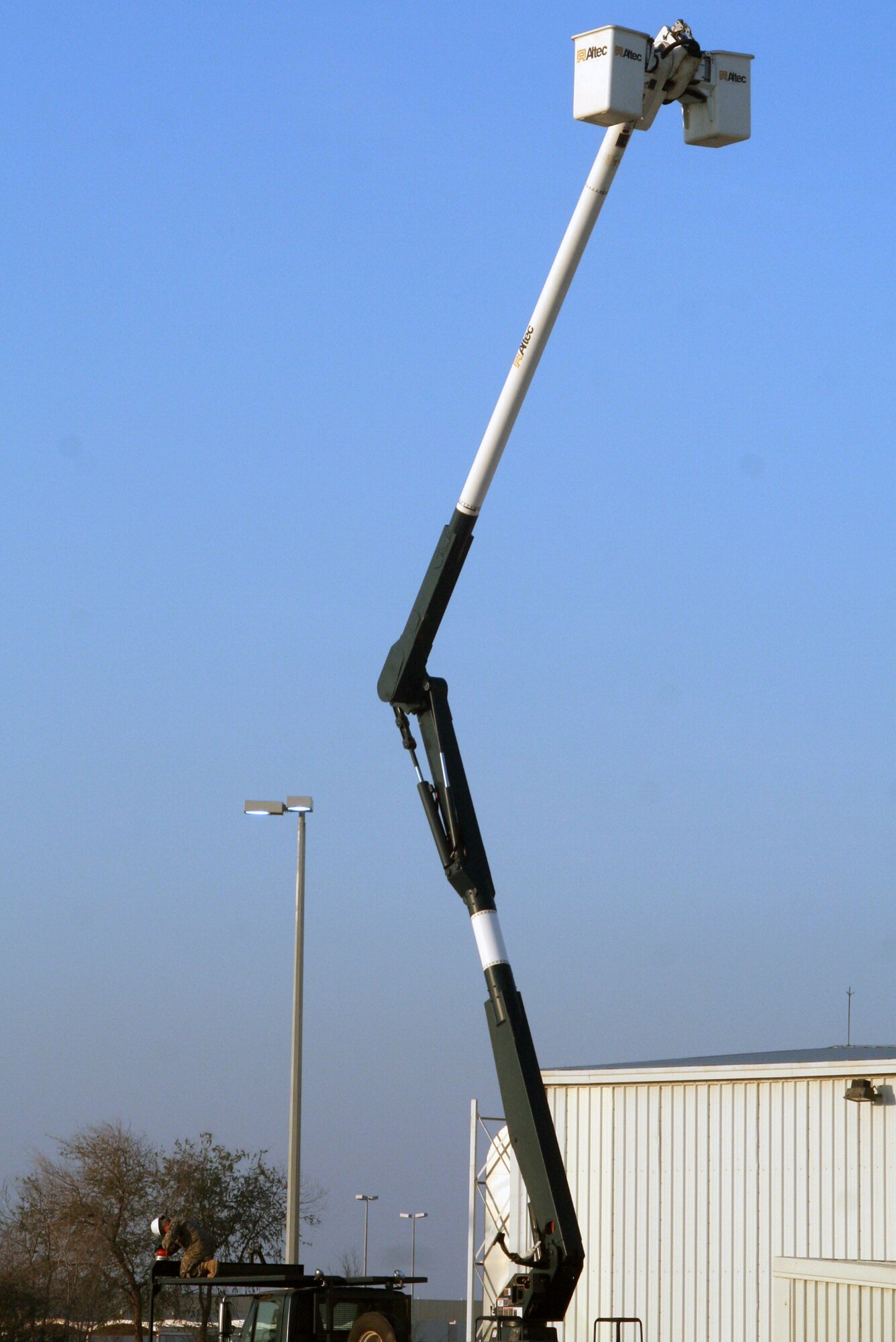 An Airman assigned to the 380th Expeditionary Civil Engineer Squadron (lower left), performs maintenance on his lift truck during operations at a non-disclosed base in Southwest Asia on Dec. 30, 2009. The 380th ECES and the 380th Air Expeditionary Wing support Operations Iraqi Freedom and Enduring Freedom and the Combined Joint Task Force-Horn of Africa.  (U.S. Air Force Photo/Tech. Sgt. Scott T. Sturkol)