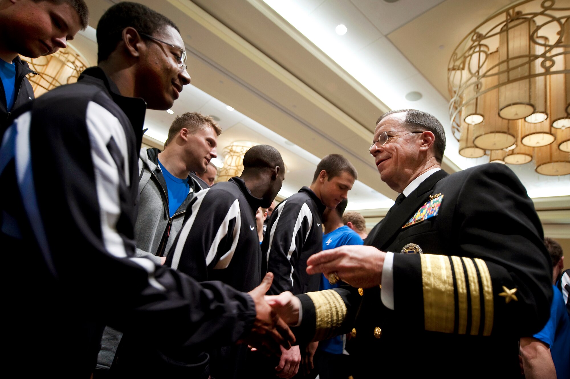 Navy Adm. Mike Mullen, chairman of the Joint Chiefs of Staff greets the U.S. Air Force Academy Falcon football team Dec. 30, 2009 prior to their appearance in the Armed Forces Bowl in Fort Worth, Texas against the University of Houston Cougars on New Years Eve.  (U.S. Navy photo/Mass Communication Specialist 1st Class Chad J. McNeeley)
