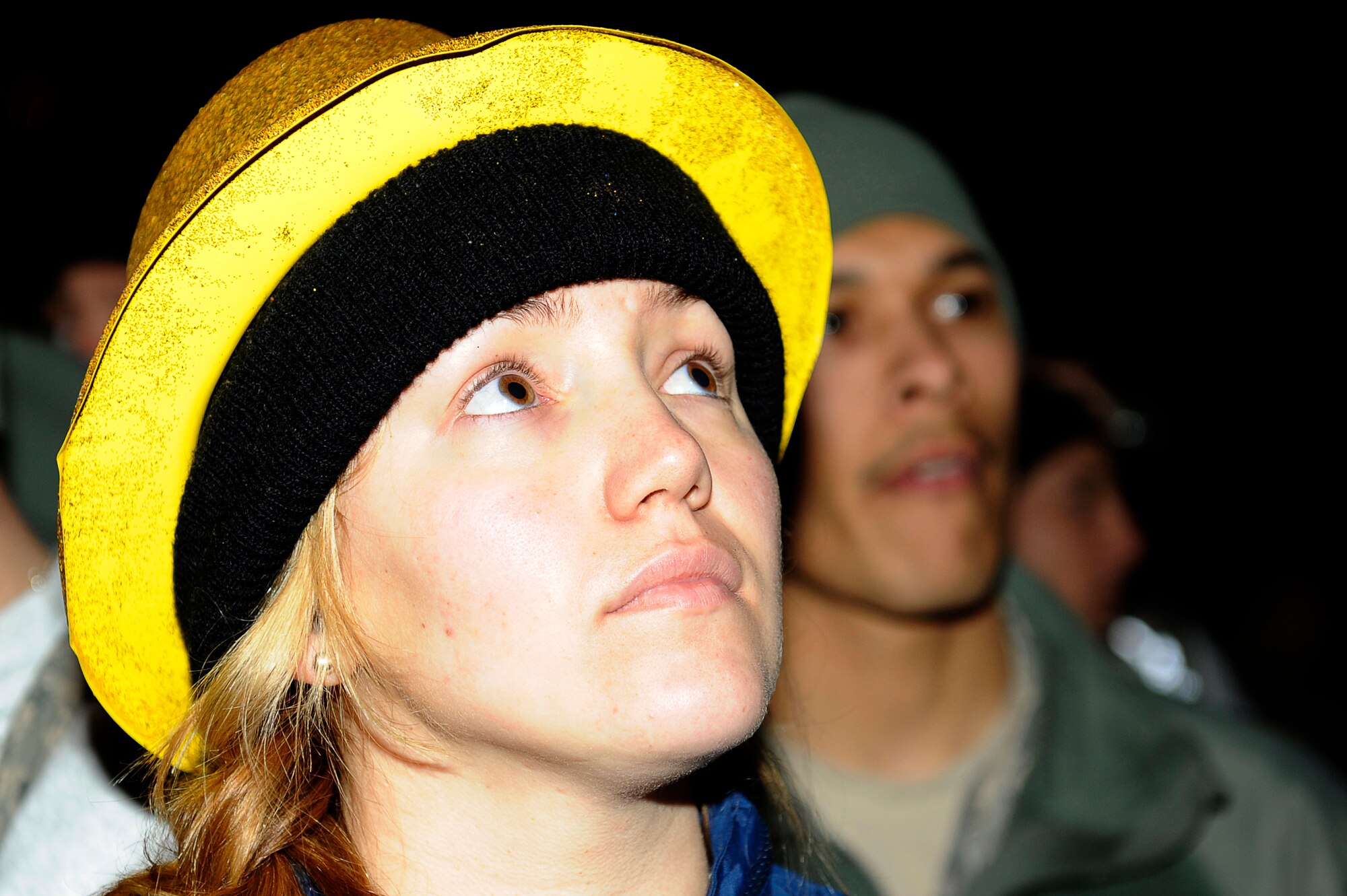 BAGRAM AIRFIELD, Afghanistan-- U.S. Air Force Airman 1st Class Teresa Lovato, 41st Electronic Aircraft Maintenance Squadron, stationed at Davis Monthan, Air Force Base, Ariz. watches as the ball begins to lower marking the start of the New Year, Dec. 31, 2009. (U.S. Air Force photo by: Tech. Sgt. Jeromy K. Cross)