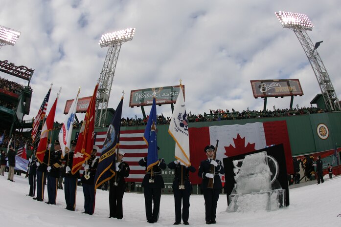 BOSTON -- Marines from 1st Battalion, 25th Marine Regiment, Air Force, Navy, Coast Guard and Army service members stand in formation on Fenway Park for a pre-game ceremony before the 2010 Bridgestone NHL Winter Classic, Jan. 1. The Air Force provided a B-2 fly over to culminate the pre-game event.(Official Marine Corps photo by Sgt. Randall A. Clinton)