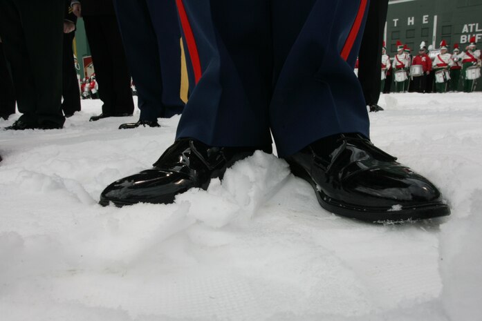 BOSTON -- A Marine from 1st Battalion, 25th Marine Regiment,  stands in the snow-covered Fenway Park, as part of a pre-game ceremony before the 2010 Bridgestone NHL Winter Classic, Jan. 1. The Air Force provided a B-2 fly over to culminate the pre-game event.(Official Marine Corps photo by Sgt. Randall A. Clinton)