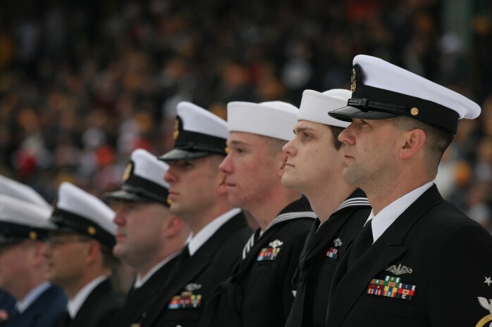 BOSTON -- Marine Corps, Air Force, Navy, Coast Guard and Army service members stand in formation on Fenway Park for a pre-game ceremony before the 2010 Bridgestone NHL Winter Classic, Jan. 1. The Air Force provided a B-2 fly over to culminate the pre-game event.(Official Marine Corps photo by Sgt. Randall A. Clinton)