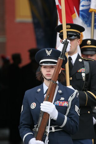 BOSTON -- Marine Corps, Air Force, Navy, Coast Guard and Army service members march the American Flag and their service colors onto Fenway Park for a pre-game ceremony before the 2010 Bridgestone NHL Winter Classic, Jan. 1. The Air Force provided a B-2 fly over to culminate the pre-game event.(Official Marine Corps photo by Sgt. Randall A. Clinton)