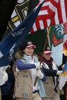 BOSTON -- Local Girl Scouts march onto Fenway Park as part of a pre-game ceremony before the 2010 Bridgestone NHL Winter Classic, Jan. 1. The event included period actors, police and firemen and military service members carrying the American Flag and their respective unit's colors onto the field. (Official Marine Corps photo by Sgt. Randall A. Clinton)