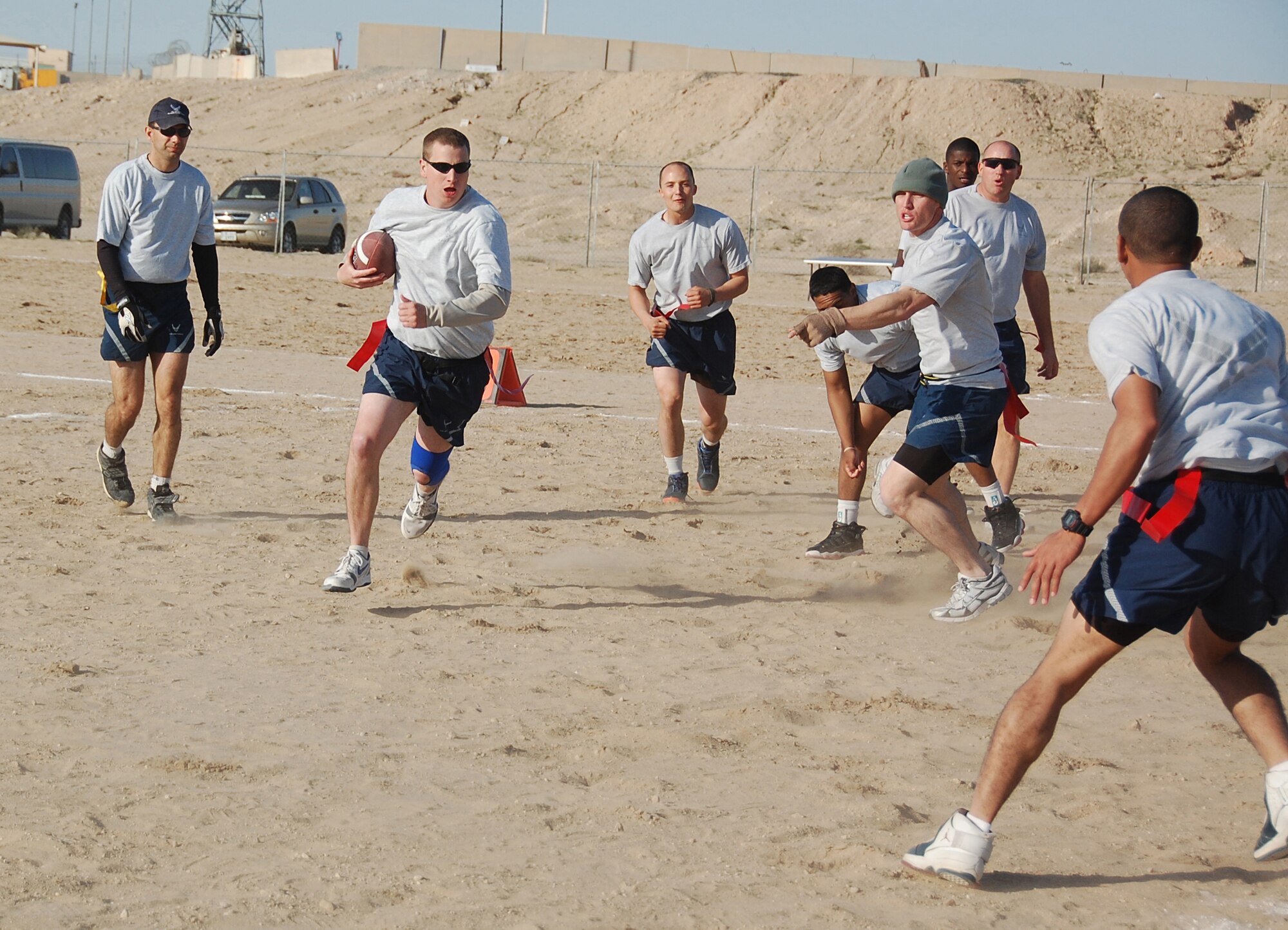 Staff Sgt. Matthew Roberts, 386th Expeditionary Security Forces Squadron, runs the open field toward the endzone for a touchdown against the 386th Expeditionary Mission Support Group during the New Year's Day Dust Bowl championship game Jan. 1, 2010 at an air base in Southwest Asia. The 386th ESFS defeated the 386th EMSG 40-20 to defend their flag football championship title. (U.S. Air Force photo/Staff Sgt. Lindsey Maurice)