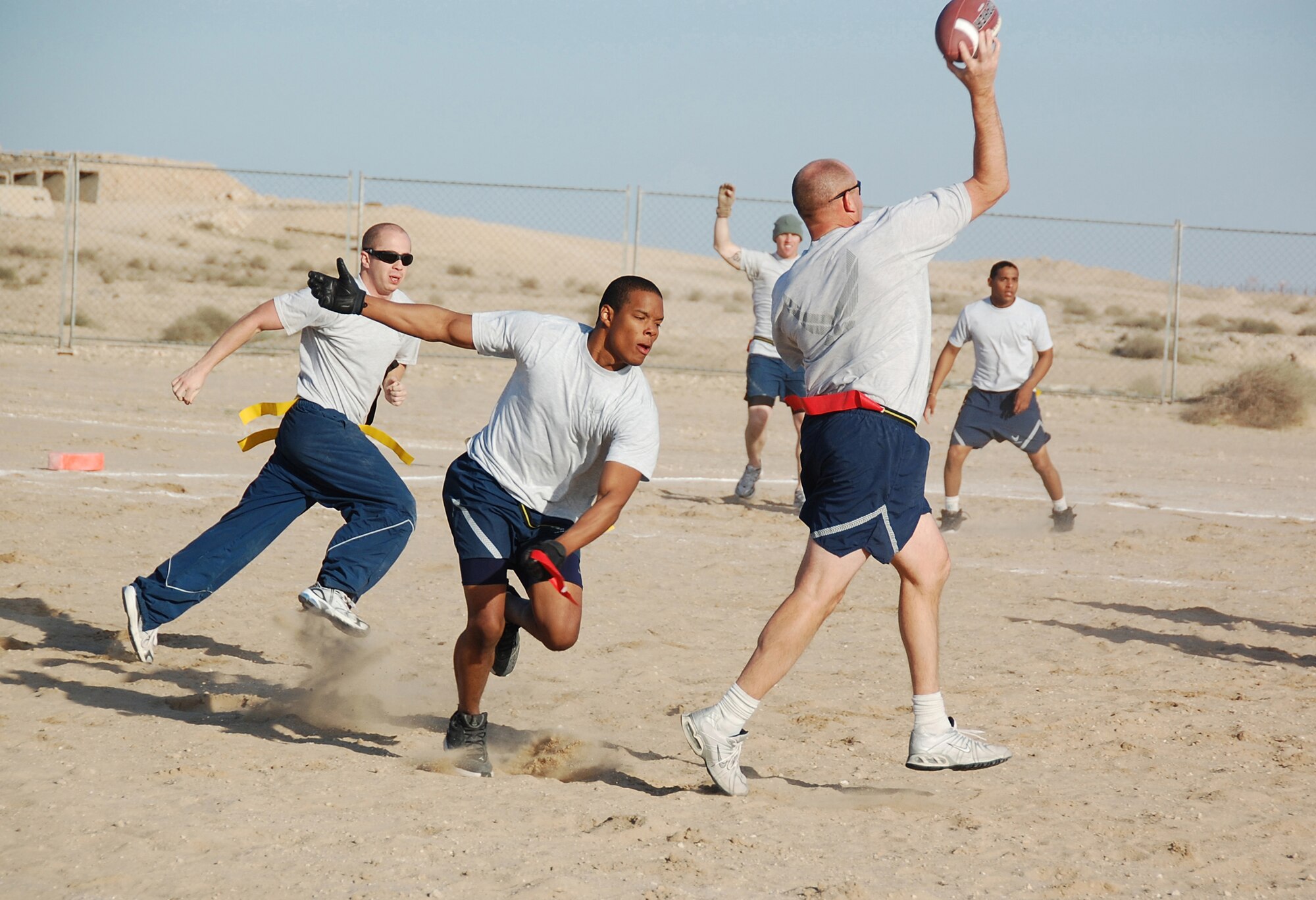 Senior Airman Deshaun Jones, 386th Expeditionary Mission Support Group, sacks 386th Expeditionary Security Forces Squadron quarterback Master Sgt. Jonathan Mehringer during the New Year's Day Dust Bowl championship game Jan. 1, 2010 at an air base in Southwest Asia. The 386th ESFS rallied from a 12-0 halftime score to defeat the 386th EMSG 40-20. (U.S. Air Force photo/Staff Sgt. Lindsey Maurice)