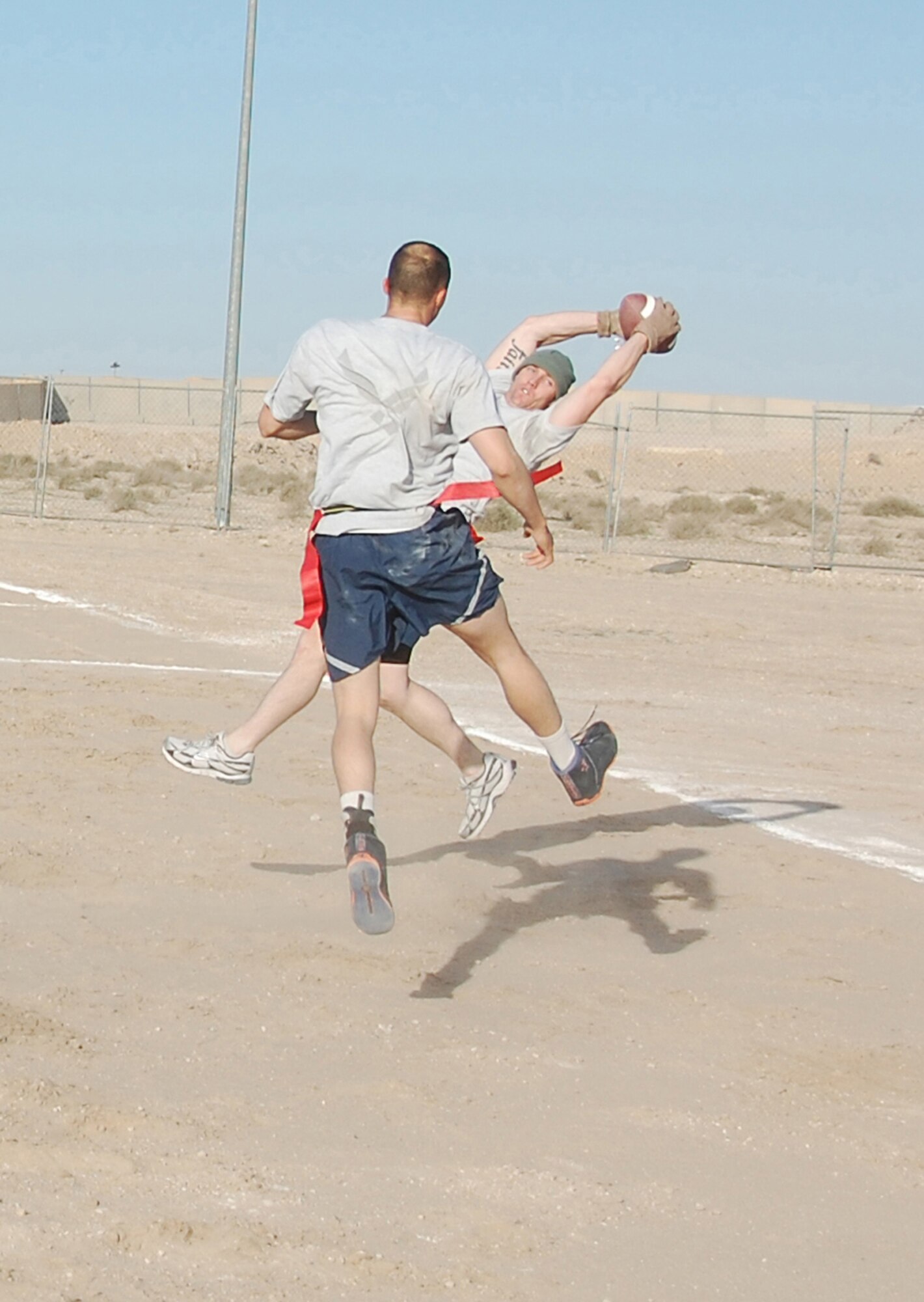 Staff Sgt. Matthew Walsh, 386th Expeditionary Security Forces Squadron, makes a diving catch for a touchdown in the New Year's Day Flag Dust Bowl championship game Jan. 1, 2010 against the 386th Expeditionary Mission Support Group at an air base in Southwest Asia. The 386th ESFS defeated the 386th Expeditionary Civil Engineer Squadron fire department, 386th Expeditionary Logistics Readiness Squadron and 31st EMSG for the flag football tournament trophy. (U.S. Air Force photo/Staff Sgt. Lindsey Maurice)