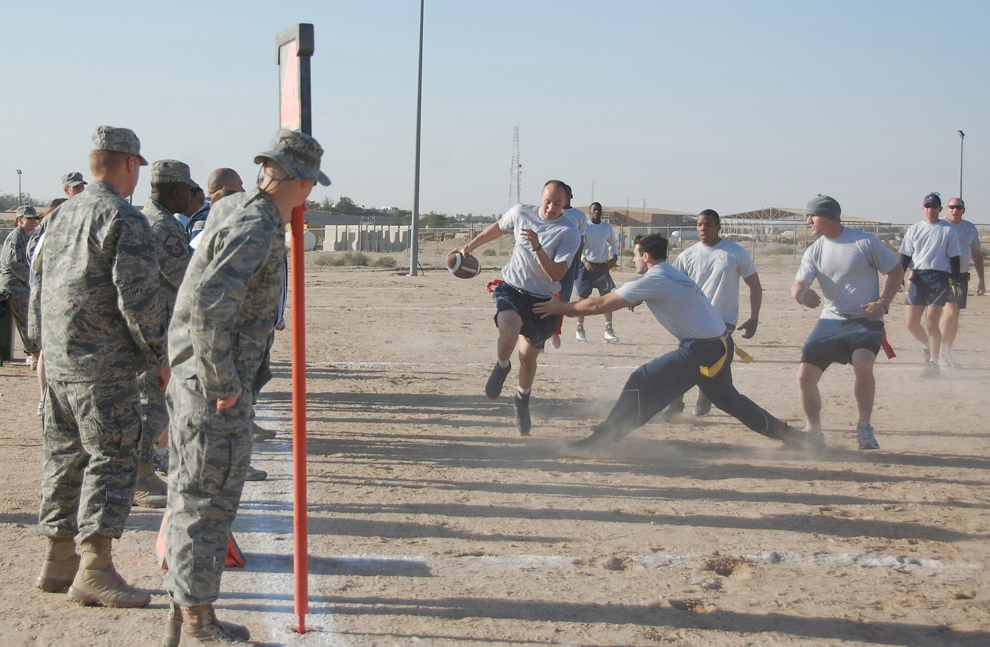 U.S. Air Force Senior Airman James Finley, 386th Expeditionary Security Forces Squadron, runs past the 386th Expeditionary Mission Support Group defense for a touchdown Jan. 1, 2010 during the New Year's Day Dust Bowl Tournament at an air base in Southwest Asia. The 386th ESFS defended its title in the 10-team, single elimination flag football tournament, defeating the 386th EMSG 40-20. (U.S. Air Force photo by Staff Sgt. Lindsey Maurice/Released)