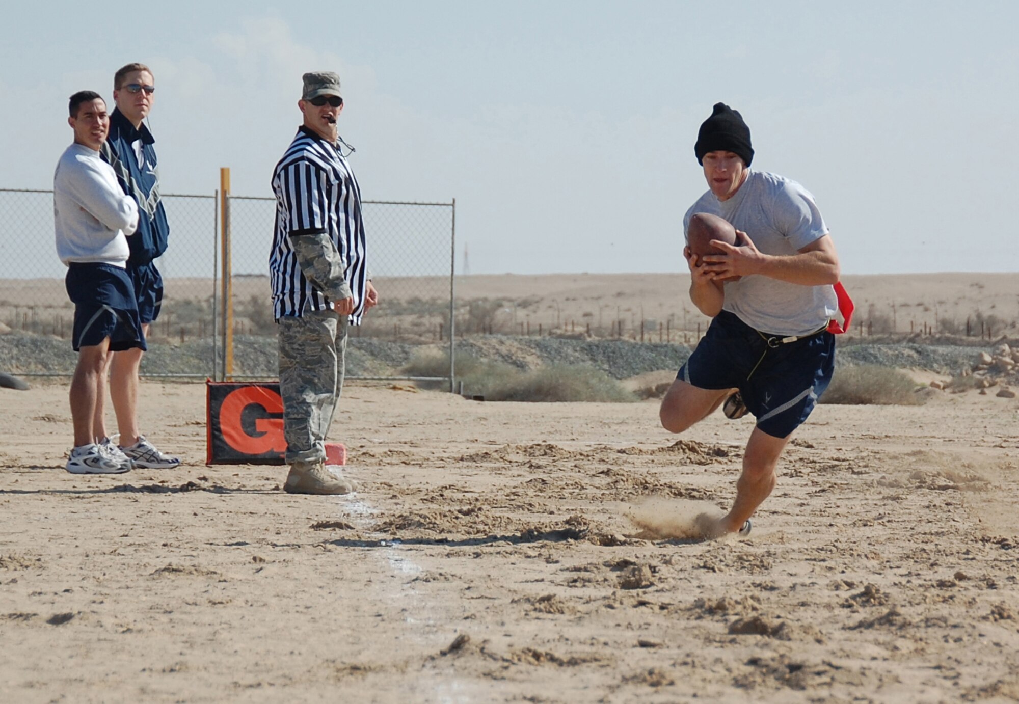 Capt. Mario Cabiao, 737th Expeditionary Airlift Squadron, runs the open field toward the endzone during a New Year's Day Dust Bowl semi-finals game Jan. 1, 2010 at an air base in Southwest Asia. The 31st Expeditionary Mission Support Group defeated the 737th EAS 7-0 to advance to the flag football championship game against the 386th Expeditionary Security Forces Squadron. (U.S. Air Force photo/Staff Sgt. Lindsey Maurice)
