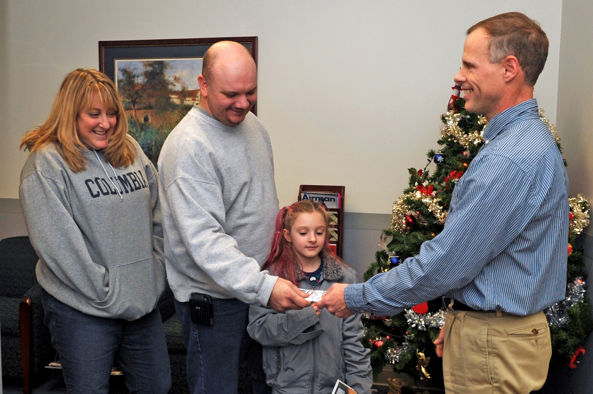 FAIRCHILD AIR FORCE BASE, Wash. – Tech. Sgt. Dewey Brown and wife, Sharon, accept $100 in vouchers from Edward Steetle, Airman and Family Readiness Center community readiness consultant, here Dec. .  The Brown family was moving from North Dakota to McChord Air Force Base and lost all of their belongings when their U-Haul trailer was stolen from a Spokane Valley hotel on 20 Dec.  (U.S. Air Force Photo / Senior Airman Darlene West)
