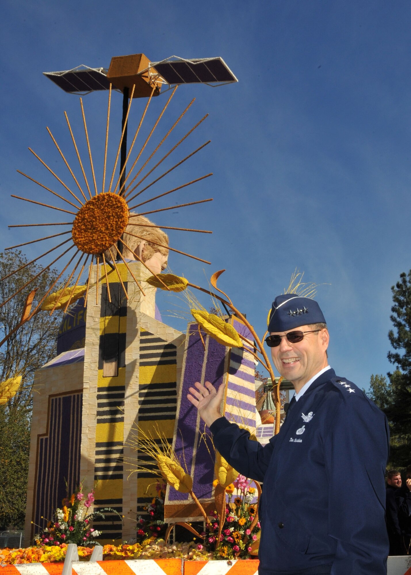 Lt. Gen. Tom Sheridan, Space and Missile Systems Center commander, checks out a Rose Parade float topped by a GPS satellite model, Dec. 31. All floats in the parade are covered with flowers, seeds and other plant materials. It takes hundreds of volunteer man-hours to decorate the floats.   (Photo by Lou Hernandez)