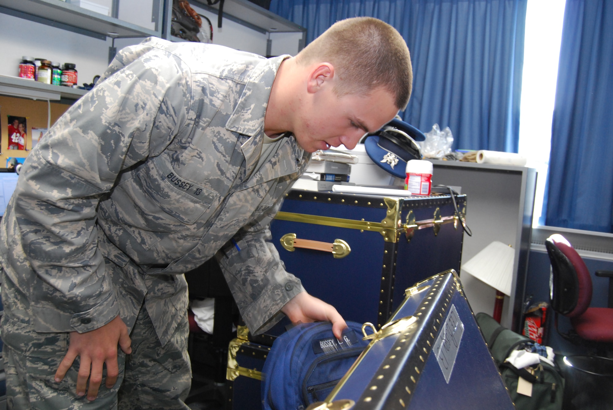 Air Force Academy Cadet 4th Class Lee Bussey pulls personal belongings out of a trunk in his new dormitory in the Academy's Vandenberg Hall Jan. 4, 2010. Cadet Bussey and his roommates are among approximately 450 cadets from Cadet Squadrons 02, 04, 06 and 08 who recently moved into renovated dorms in Vandenberg Hall. (U.S. Air Force photo/Staff Sgt. Don Branum)