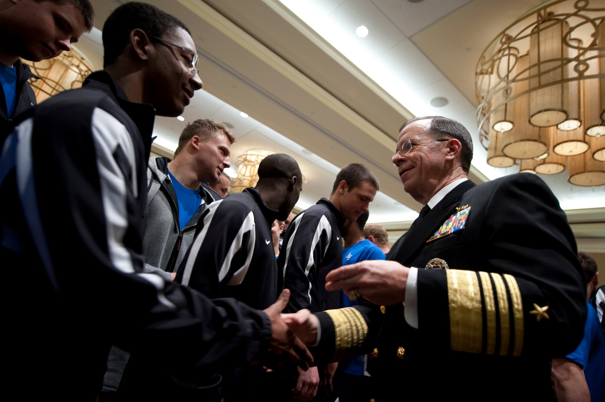 Adm. Mike Mullen, chairman of the Joint Chiefs of Staff, greets members of the Air Force Academy Falcons football team Dec. 30, 2009, during a visit the day before the Armed Forces Bowl in Fort Worth, Texas.  The Falcons won the bowl game, defeating the University of Houston Cougars 47-20.  (Defense Department photo/Petty Officer 1st Class Chad J. McNeeley)