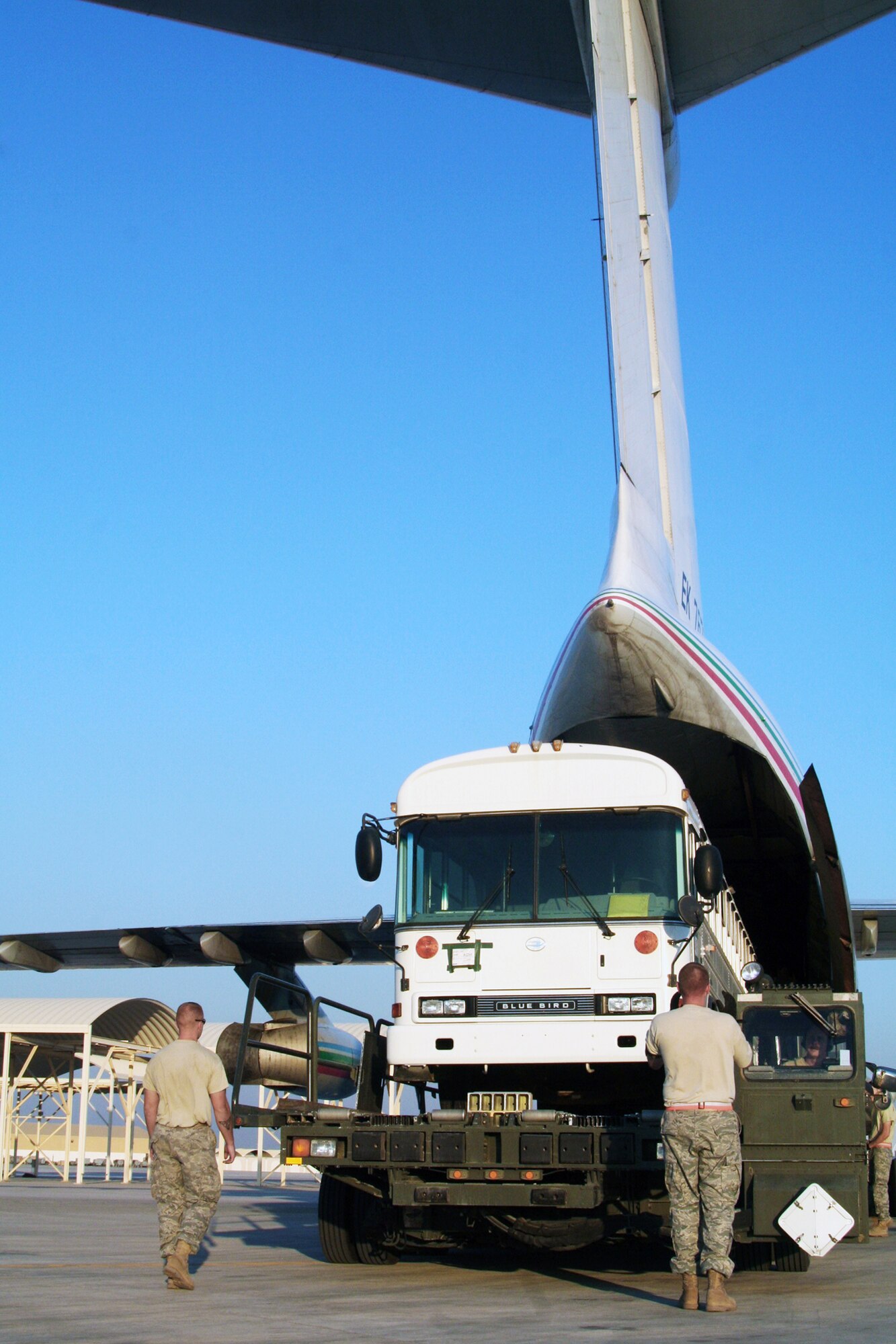 Air transportation Airmen assigned to the 380th Expeditionary Logistics Readiness Squadron Air Terminal Operations Center load a 44-passenger bus onto a Russian-built IL-76 transport plane during operations Dec. 30, 2009, at an air base in Southwest Asia. The 380th Air Expeditionary Wing supports operations Iraqi Freedom and Enduring Freedom and the Combined Joint Task Force-Horn of Africa. (U.S. Air Force photo/Tech. Sgt. Scott T. Sturkol)