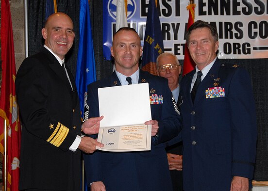 McGHEE TYSON AIR NATIONAL GUARD BASE, Tenn. -- Senior Master Sgt. Jeff D. Watson, center, the superintendent of logistics for The I.G. Brown Air National Guard Training and Education Center here, receives an award from the East Tennessee Military Affairs Council (ETMAC) for outstanding service at the 27th Annual Veteran's Day Commemoration luncheon in Knoxville, Nov. 11, 2009.  (U.S. Air Force photo/Released)