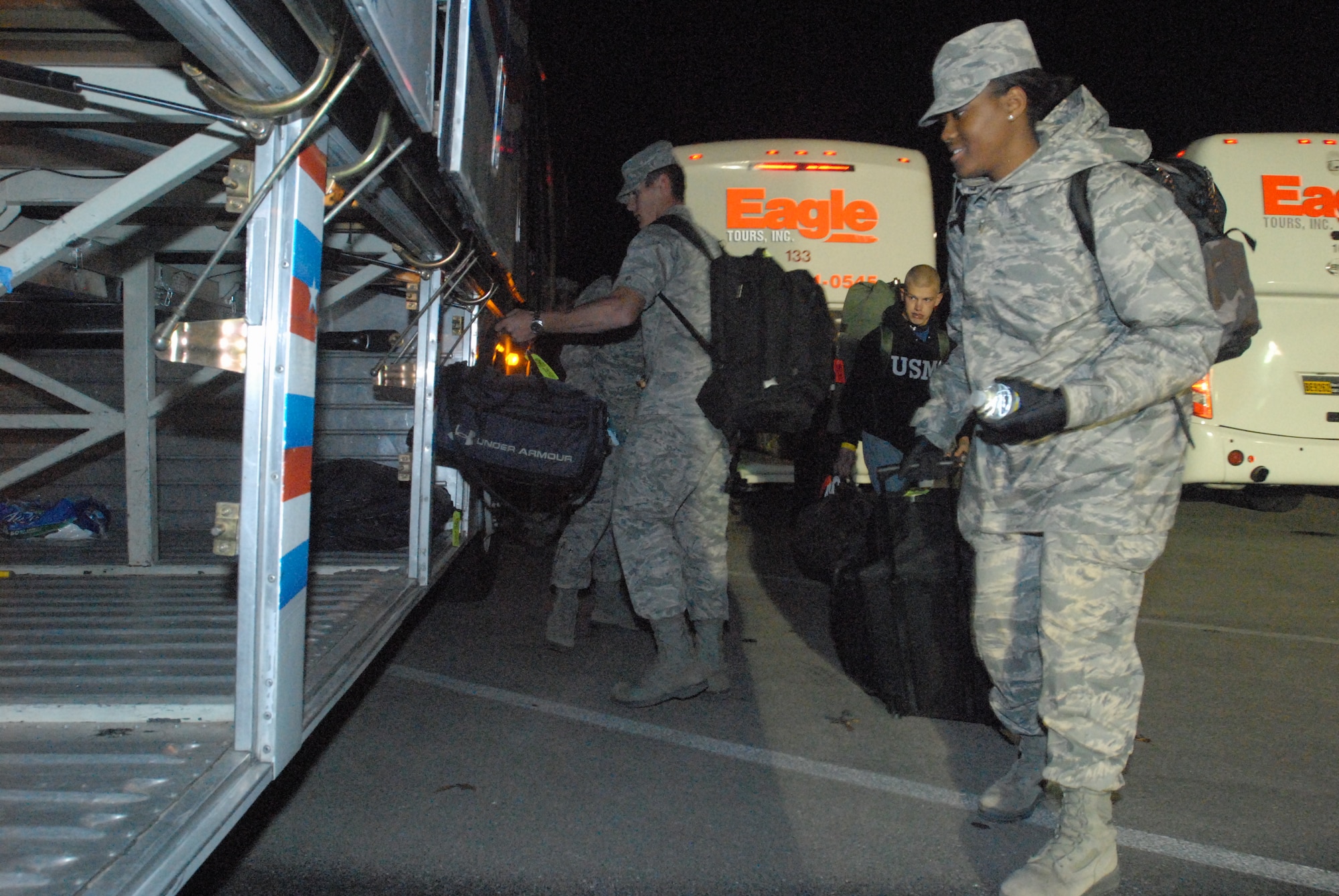 Military personnel assigned to the Goodfellow AFB, Texas for technical training, load their bags and themselves onto buses outside Carswell Field House for rides to area airports prior to going home for the holidays on Dec. 18.  Permanent party personnel assisted over 500 military technical training students in traveling home for the holidays during the event known at Goodfellow as Exodus. (US Air Force photo by Master Sgt. Randy Mallard)