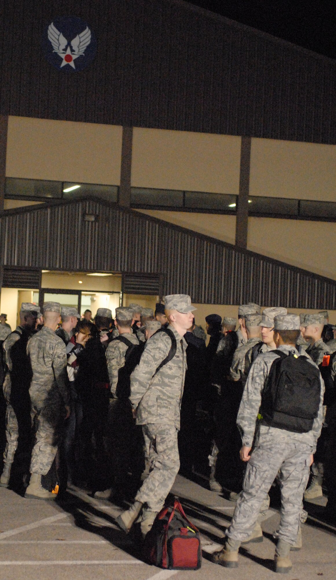 Airmen assigned to the 17th Training Group, Goodfellow AFB, Texas wait outside Carswell Field House to load unto buses for rides to area airports prior to going home for the holidays on Dec. 18. Permanent party personnel assisted over 500 military technical training students in traveling home for the holidays during the event known at Goodfellow as Exodus. (US Air Force photo by Master Sgt. Randy Mallard)