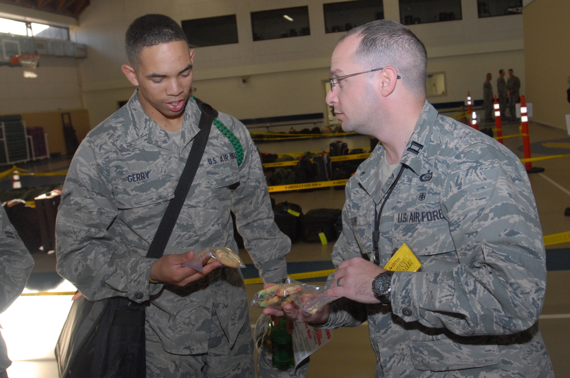 Captain Boris Shif, a member of the 316th Training Squadron, hands out homemade cookies to Airman Stephen Gerry on Dec. 18.  Airman Gerry assigned to the 316th Training Squadron, going through his technical training at Goodfellow AFB, Texas, is preparing to leave the local area for the holidays. Permanent party personnel assisted over 500 military technical training students in traveling home for the holidays during the event known at Goodfellow as Exodus. (US Air Force photo by Master Sgt. Randy Mallard)