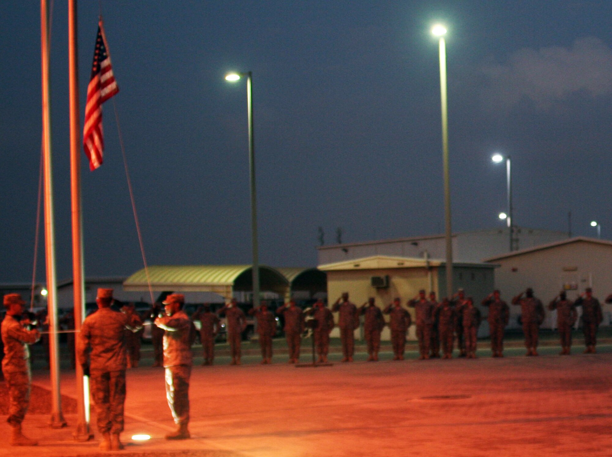 Airmen and Soldiers deployed to a non-disclosed base in Southwest Asia participate in a New Year's Day retreat ceremony signaling the end of the duty day Jan. 1, 2010.  Among the participants included Airmen from the 380th Air Expeditionary Wing which supports Operations Iraqi Freedom and Enduring Freedom and the Combined Joint Task Force-Horn of Africa.  (U.S. Air Force Photo/Tech. Sgt. Scott T. Sturkol)  
