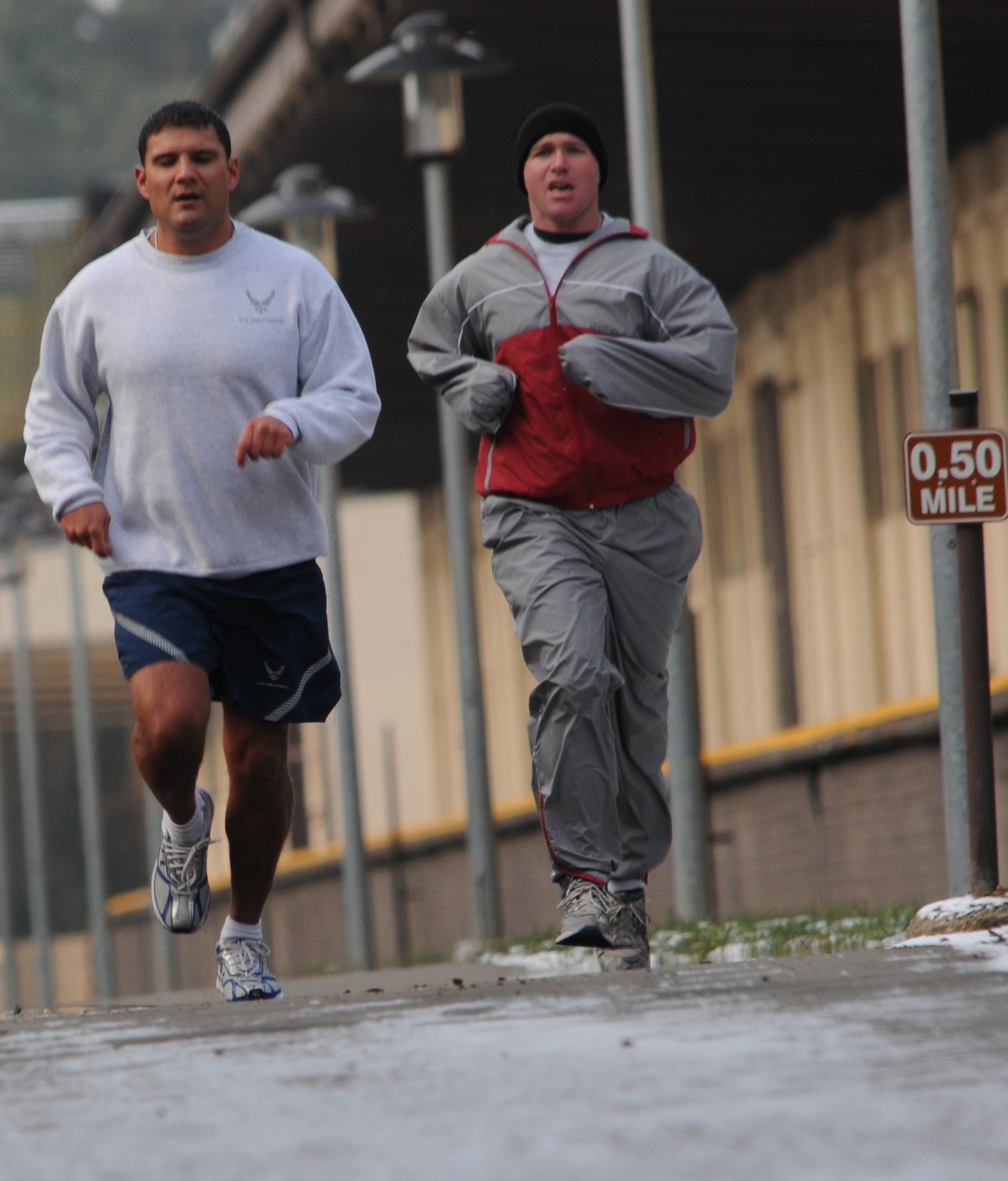 U.S. Air Force Tech. Sgt. Stephen Elizondo and Tech. Sgt. Mark Malloy, both 1st Communications Maintenance Squadron special communications team members run the 1.5 mile during their physical training assessment, Ramstein Air Base, Germany, Dec. 16, 2009. Airmen across the Air Force are getting ready for the new pt standards. (U.S. Air Force photo by Airman 1st Class Alexandria Mosness)