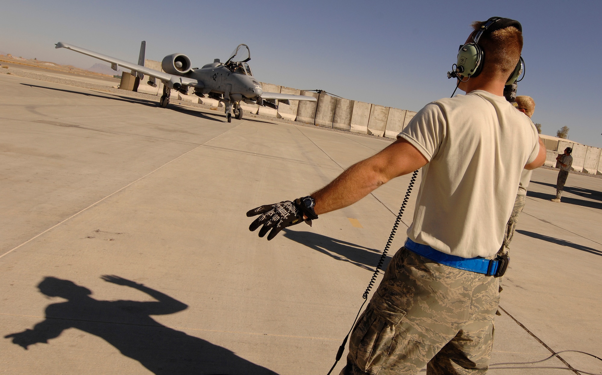 Staff Sgt. Christopher Zermer, 451st Expeditionary Aircraft Maintenance Squadron, guides an A-10 Thunderbolt II at Kandahar Airfield, Afghanistan, Jan. 1, 2010. (U.S. Air Force photo by Staff Sgt. Dayton Mitchell/Released)