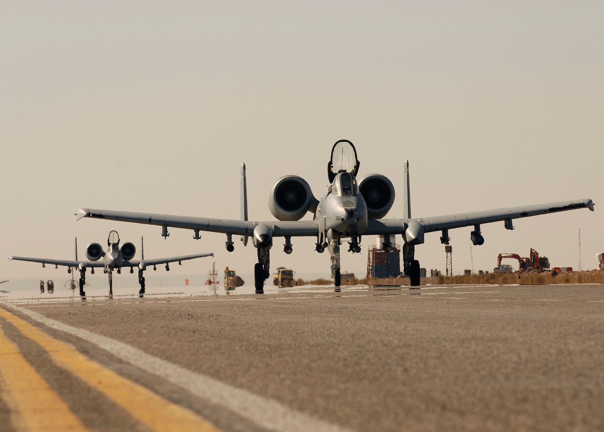 Two A-10Cs, flown by Lt. Col. Michael Millen, 354th Expeditionary Fighter Squadron commander, and Col. John Cherrey, 451st Expeditionary Operations Group commander, taxi down the runway after completing ten thousand hours of flying during a six-month deployment at Kandahar Airfield, Afghanistan, Jan. 1, 2010.  (U.S. Air Force photo by Staff Sgt. Dayton Mitchell /Released)