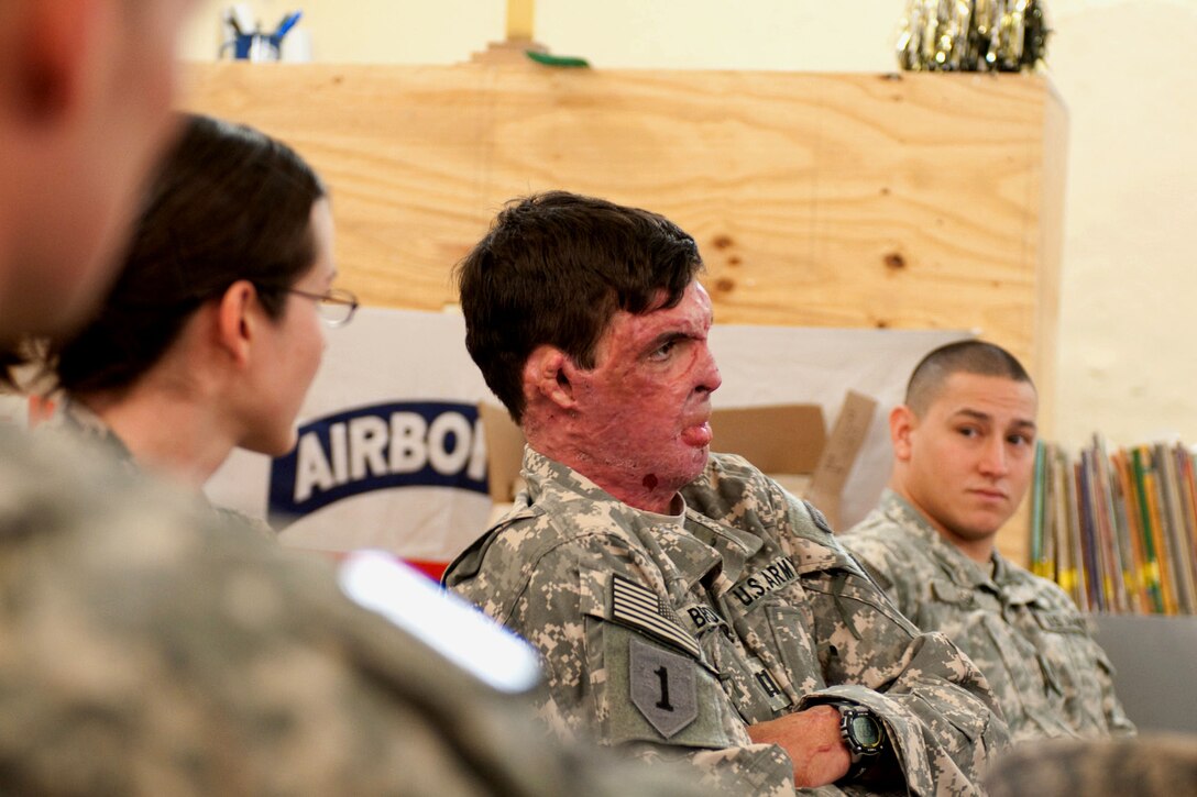 Army Capt. Sam Brown tells the story of his injury to paratroopers of the 82nd Airborne Division’s 1st Advise and Assist Brigade while visiting Camp Ramadi, Iraq, Dec. 29, 2009, as part of Operation Proper Exit. At left is his wife, Army Capt. Amy Brown, a dietitian with 47th Combat Support Hospital. U.S. Army photo by Spc. Michael J. MacLeod
