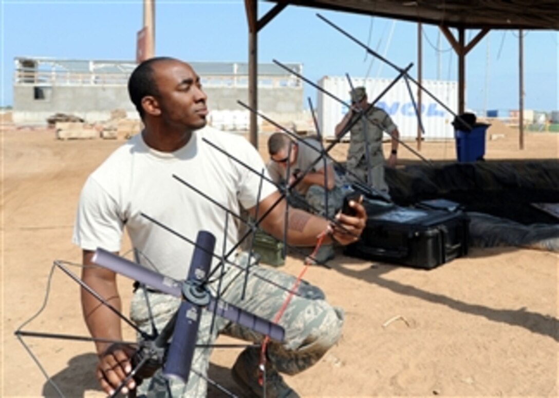U.S. Air Force Senior Airman Carl Johnson sets up a PRC-117 tactical satellite during training at Camp Lemonier, Djibouti, on Dec. 29, 2009.  Hands-on training gives personnel the skills necessary to install, operate and maintain these systems in realistic field environments.  