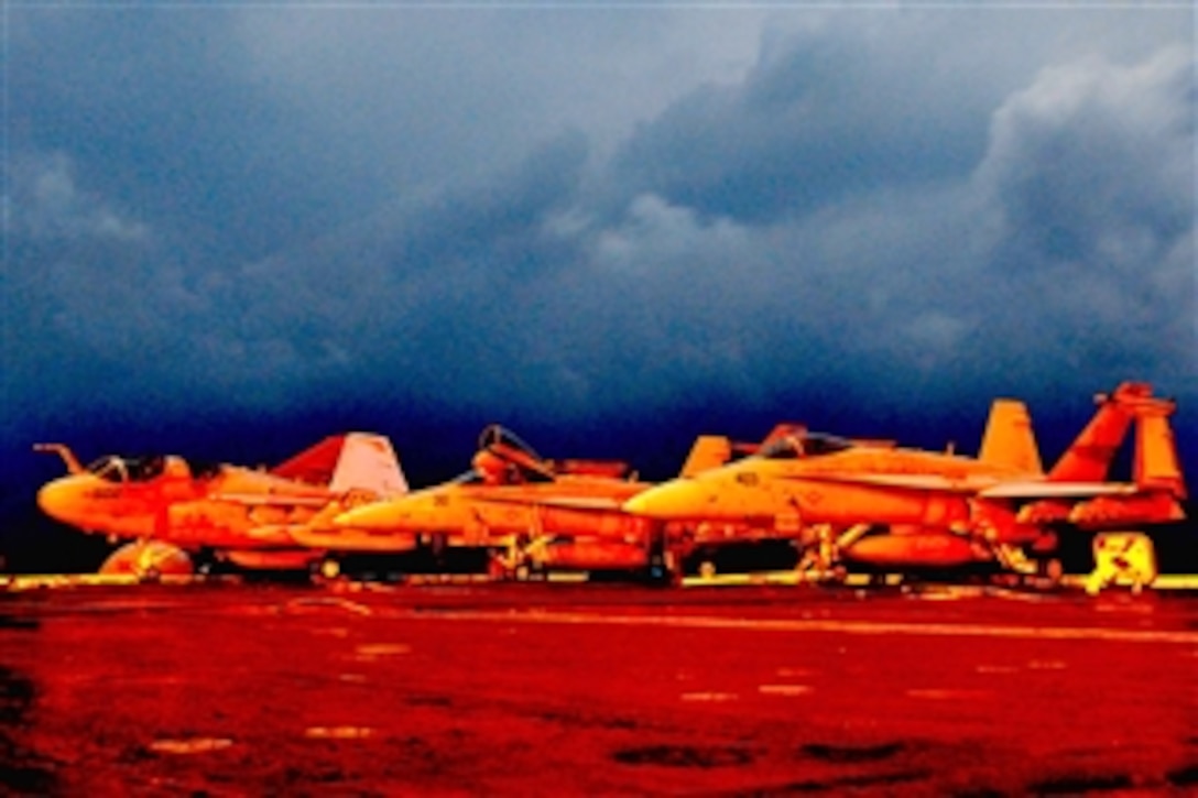 Aircraft are on the flight deck of the USS Nimitz under way in the North Arabian Sea at midnight, Jan, 1, 2010. 