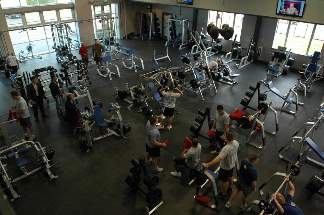 Several visitors begin taking advantage of their newly improved weight room immediately after Phillip’s Halls grand re-opening here, Jan. 4. Although the weight room was not completely changed, the center podium that used to be there was taken out, allowing space for more attendees to pump iron.