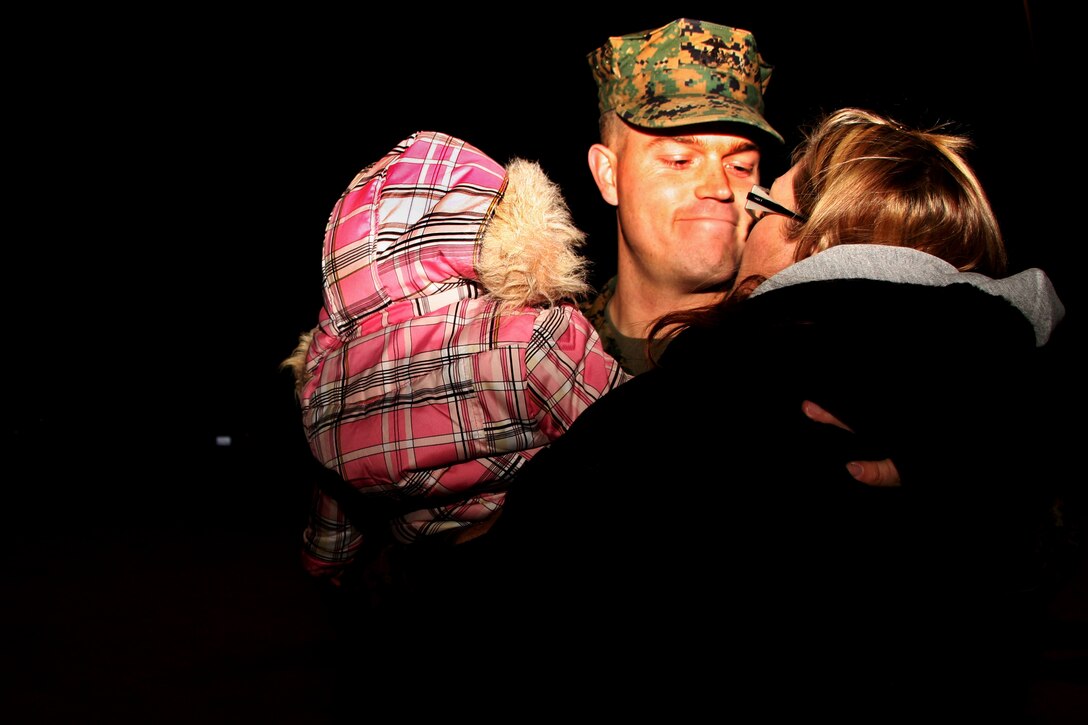 Sgt. Erik Frederiksen, a squad leader with Company G, 2nd Battalion, 7th Marine Regiment, hugs his wife, Leanne, and 7-month-old daughter, Eleanor, prior to departing the Combat Center this week for a six-month deployment with the 31st Marine Expeditionary Unit. 2nd Bn., 7th Marines is the first battalion within their regiment to deploy as the ground combat element with any MEU.