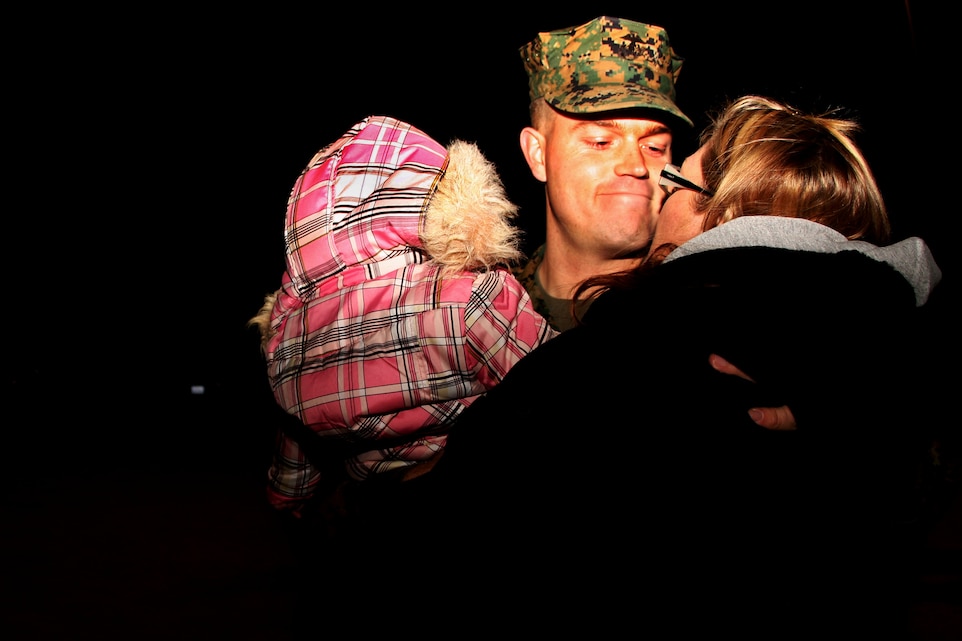 Sgt. Erik Frederiksen, a squad leader with Company G, 2nd Battalion, 7th Marine Regiment, hugs his wife, Leanne, and 7-month-old daughter, Eleanor, prior to departing the Combat Center this week for a six-month deployment with the 31st Marine Expeditionary Unit. 2nd Bn., 7th Marines is the first battalion within their regiment to deploy as the ground combat element with any MEU.