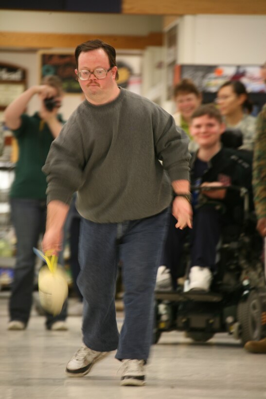 Three-time Special Olympian Edward Harrison goes for the spare during the turkey bowling portion of the Special Olympics competition in the aisles of the Cherry Point Commissary, Jan. 5.
