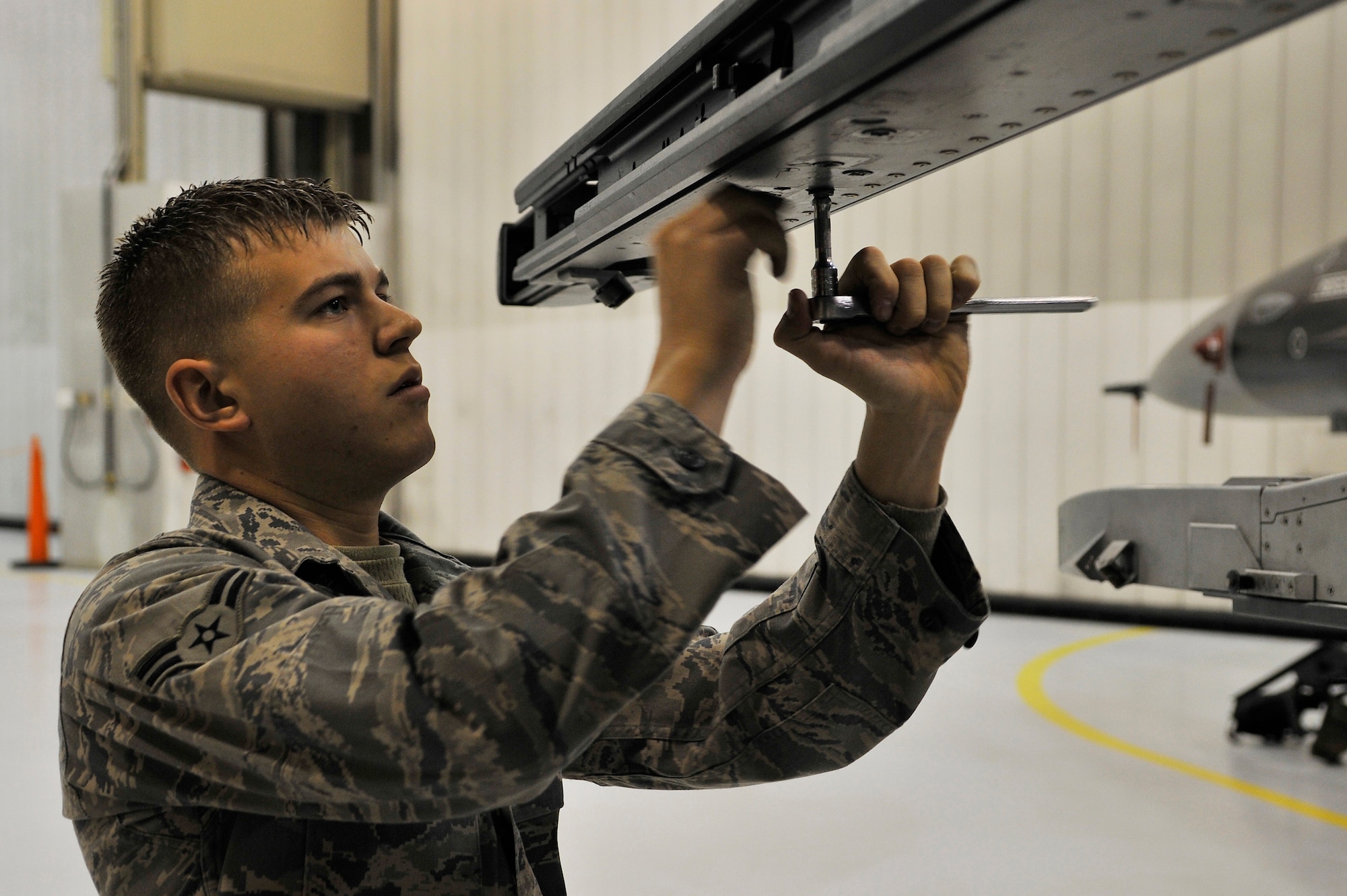 Airman 1st Class Adam Marks prepares a launcher on an F-16 Fighting Falcon during the weapons load crew of the year competition Dec. 17, 2009, Eielson Air Force Base, Alaska. Airman Marks is a weapons load crew member assigned to the 354th Aircraft Maintenance Squadron. (U.S. Air Force photo/Staff Sgt. Christopher Boitz)