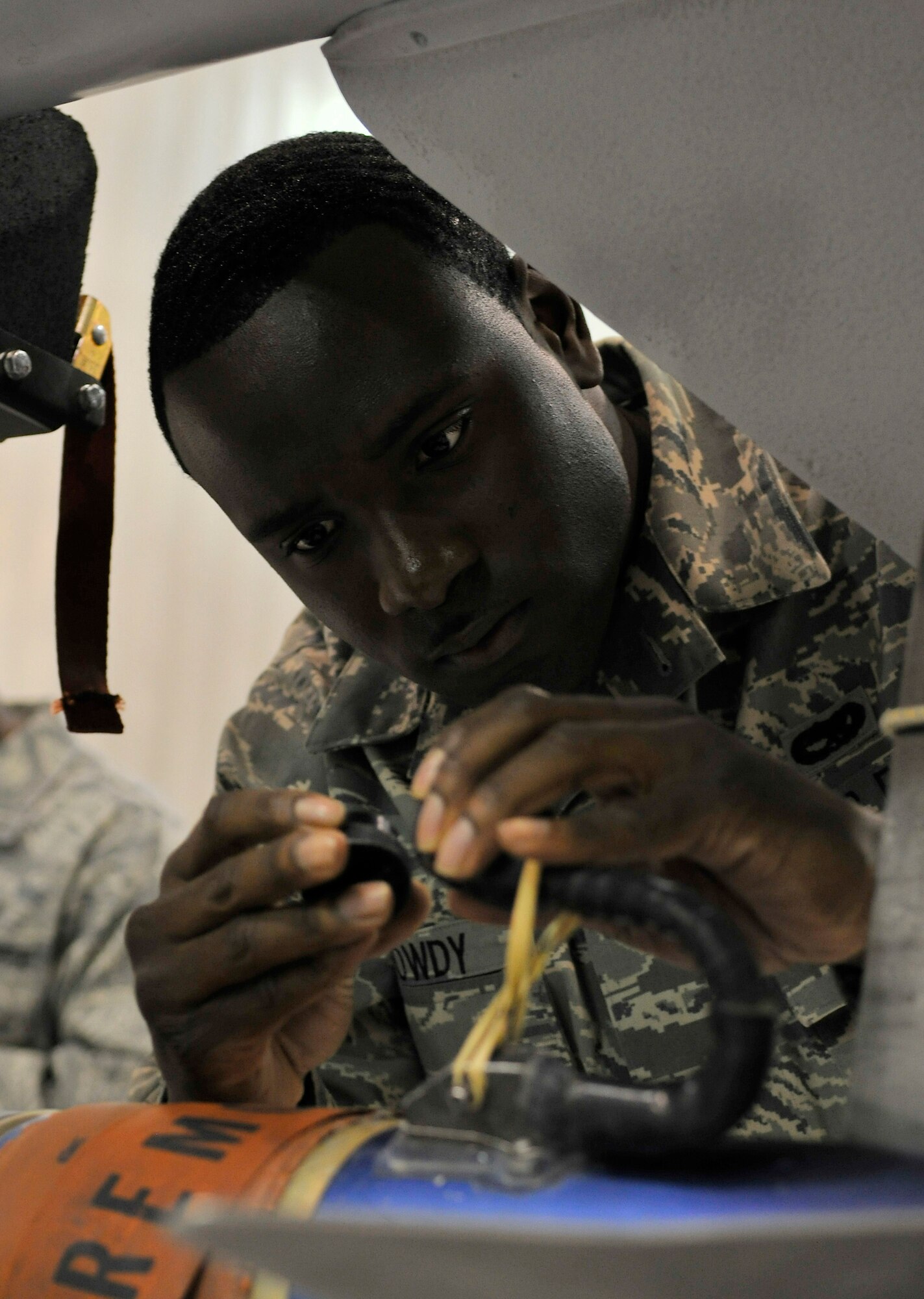 Senior Airman Cornelius Browdy inspects umbilical connectors on training munitions during the weapons load crew of the year competition Dec. 17, 2009, Eielson Air Force Base, Alaska. The umbilical connector connects the munitions to the aircraft. Airman Browdy is a weapons load crew member assigned to the 354th Aircraft Maintenance Squadron. (U.S. Air Force photo/Staff Sgt. Christopher Boitz)