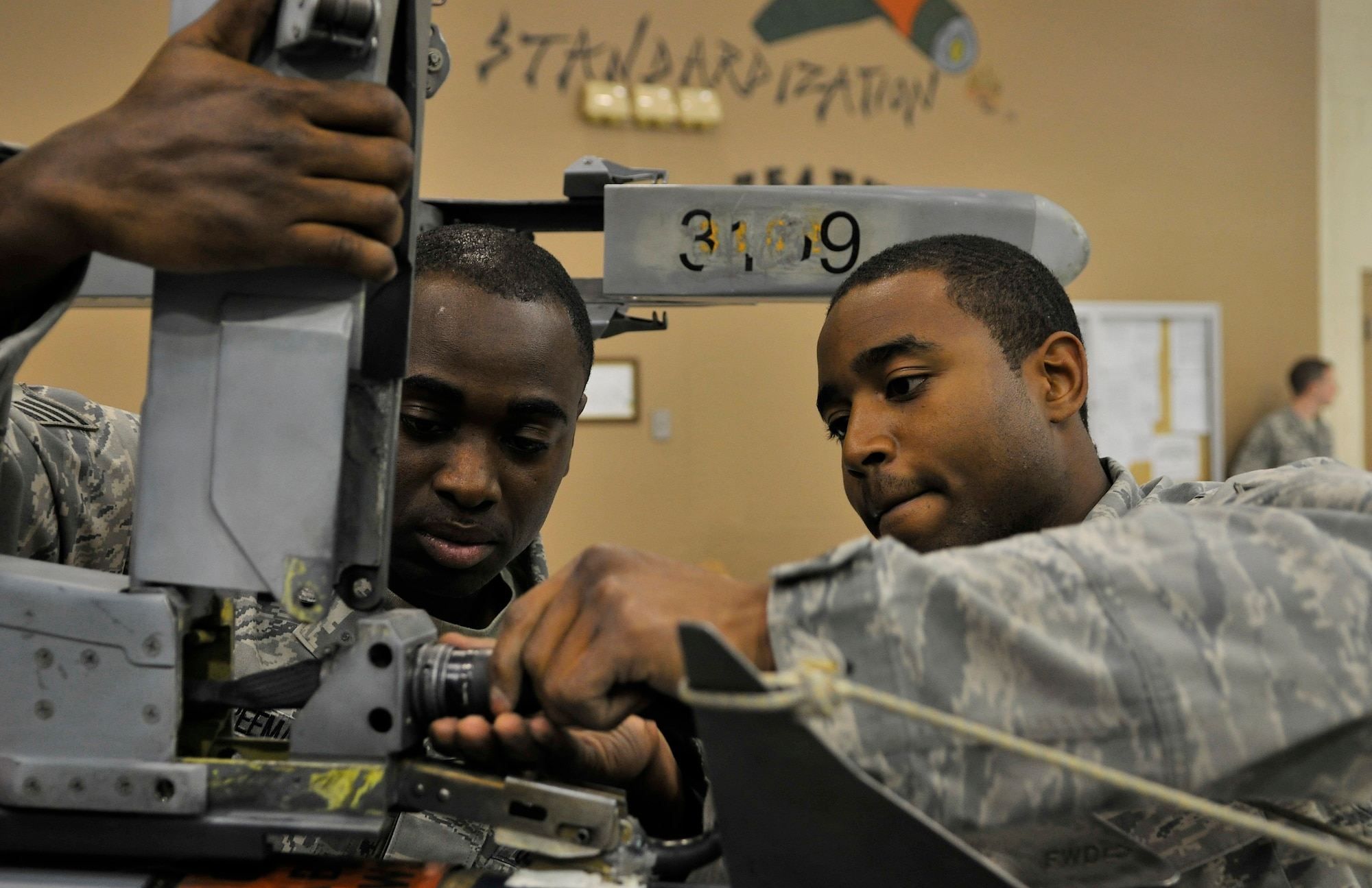 Staff Sgt. Ashley Freeman and Airman 1st Class Dexter High connect munitions to an F-16 Fighting Falcon during the weapons load crew of the year competition Dec. 17, 2009, Eielson Air Force Base, Alaska. Both are assigned to the 354th Aircraft Maintenance Squadron. (U.S. Air Force photo/Staff Sgt. Christopher Boitz)