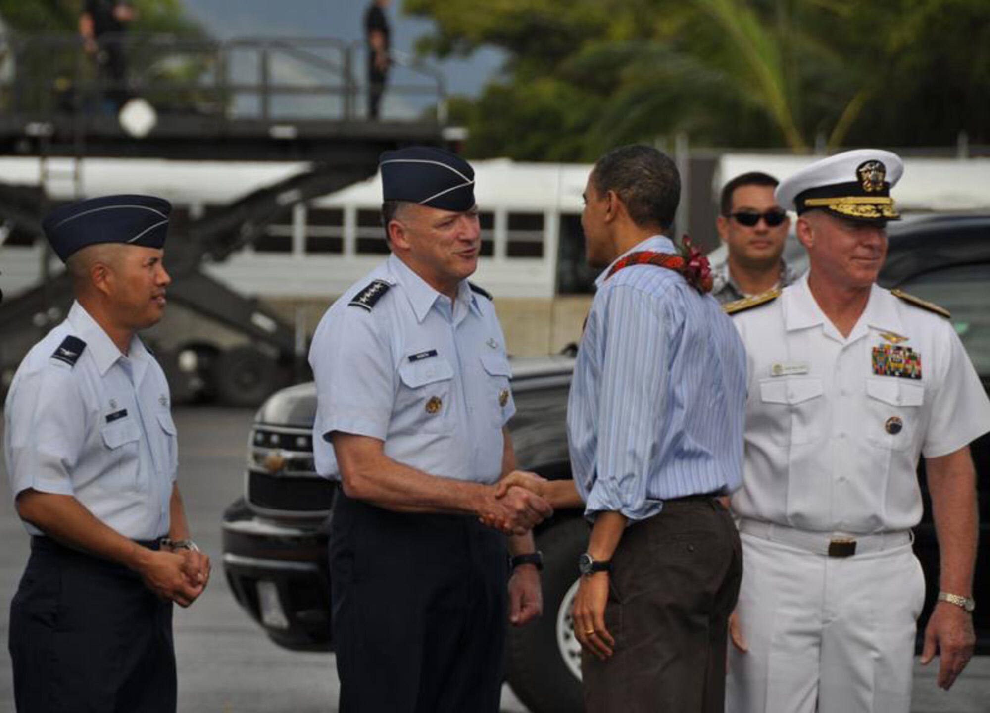 HICKAM AIR FORCE BASE, Hawaii - 15th Airlift Wing Commander (left) Col Giovanni Tuck, Pacific Air Forces Commander Gen Gary North (center) and United States Pacific Command Commander Admiral Robert F. Willard greet President of the United States Barack Obama upon his arrival to Hickam AFB, Hawaii on Dec. 24. President Obama and his family are in Hawaii for the holidays. (DoD photo by U.S.  Air Force Tech Sgt. Cohen A. Young)