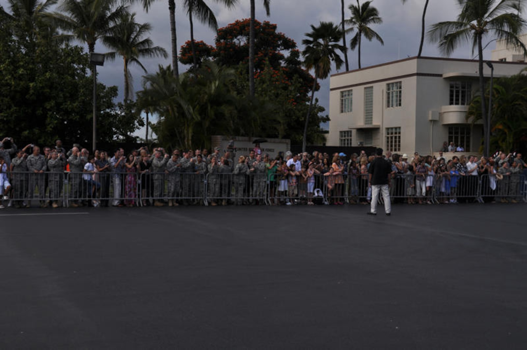 HICKAM AIR FORCE BASE, Hawaii - Airmen and their families patiently wait for the door to Air Force One to open so they can take photos of President of the United States Barack Obama and First Lady Michelle Obama upon their arrival at Hickam AFB, Hawaii on Dec. 24. President Obama, a native of Hawaii is home for the holidays. (DoD photo by U.S.  Air Force Tech Sgt. Cohen A. Young)