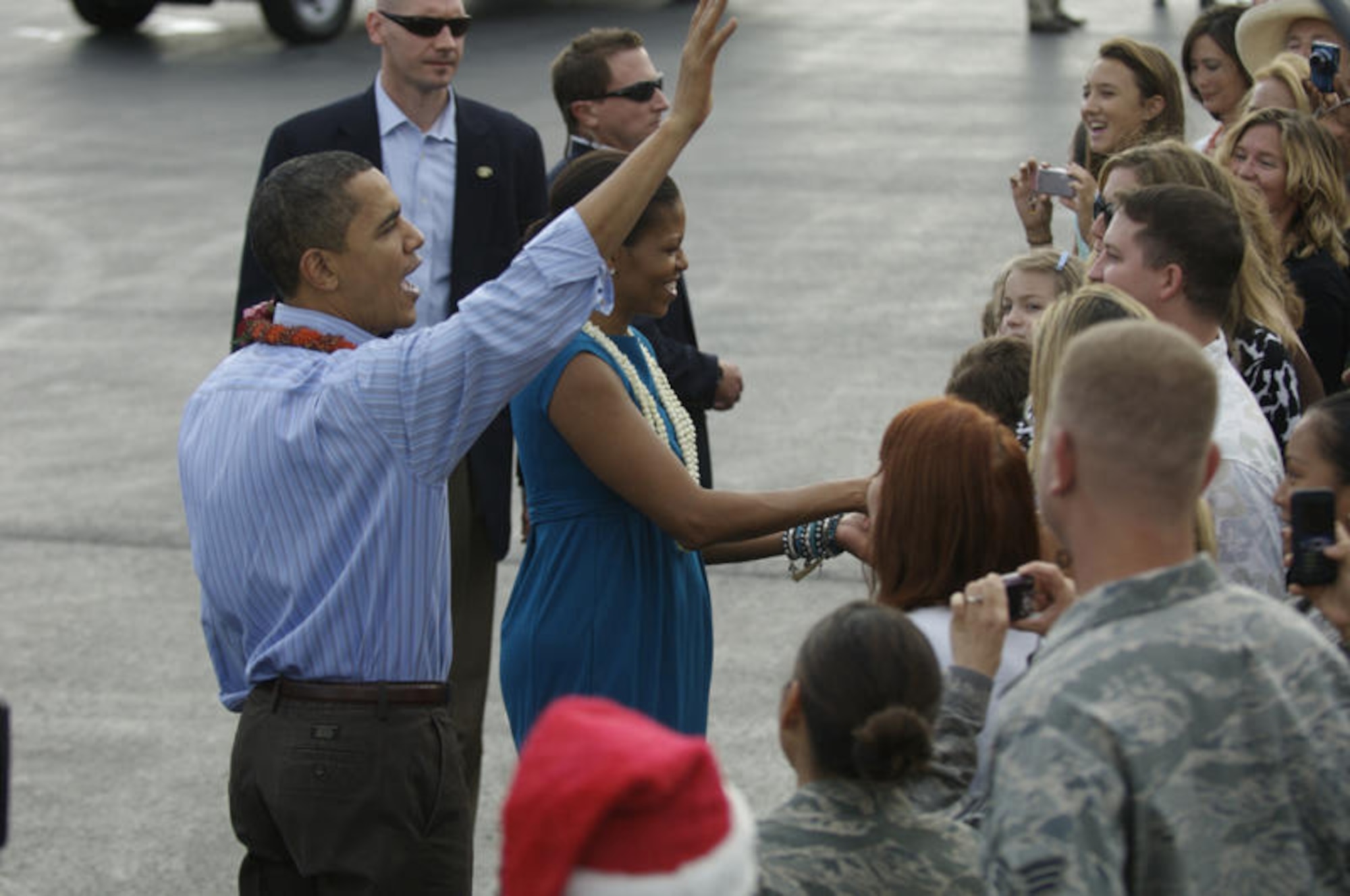 HICKAM AIR FORCE BASE, Hawaii - President of the United States Barack Obama and First Lady Michelle Obama wave and say their "Hellos" upon their arrival to Hickam AFB, Hawaii Airmen and their families on Dec. 24. President Obama, a native of Hawaii is home for the Holidays. (DMA photo by U.S.  Air Force Tech Sgt. Cohen A. Young)