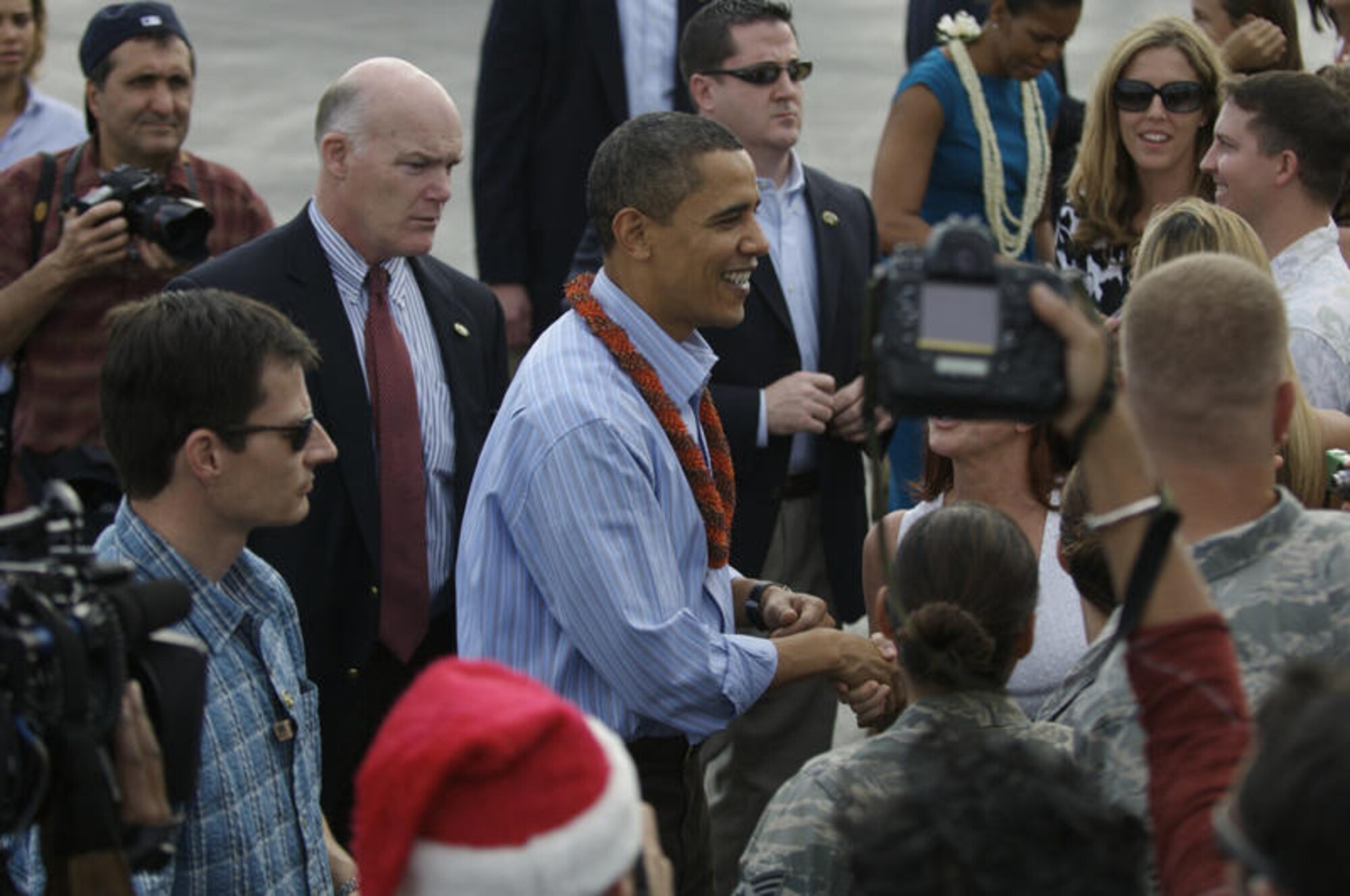 HICKAM AIR FORCE BASE, Hawaii - President of the United States Barack Obama is greeted by Airmen and their families upon his arrival to Hickam AFB, Hawaii on Dec. 24. President Obama, a native of Hawaii is home for the Holidays. (DMA photo by U.S.  Air Force Tech Sgt. Cohen A. Young)
