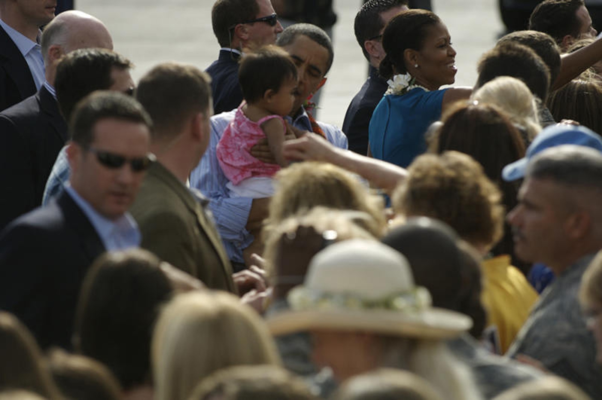 HICKAM AIR FORCE BASE, Hawaii - President of the United States Barack Obama holds an infant while greeting Airmen and their families at Hickam AFB, Hawaii on Dec. 24. President Obama, a native of Hawaii is home for the Holidays. (DMA photo by U.S.  Air Force Tech Sgt. Cohen A. Young)