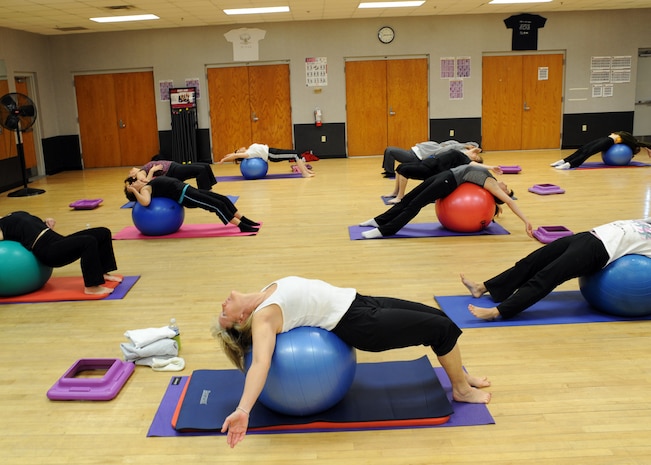 Core Fusion class members perform a core muscle fitness routine at the Fitness and Sports Center here Jan. 4. The Core Fusion class is led by a certified personal trainer who has held the class for more than one year. Classes are held three times per week. (U.S. Air Force photo/Senior Airman Katie Gieratz)(RELEASED)
