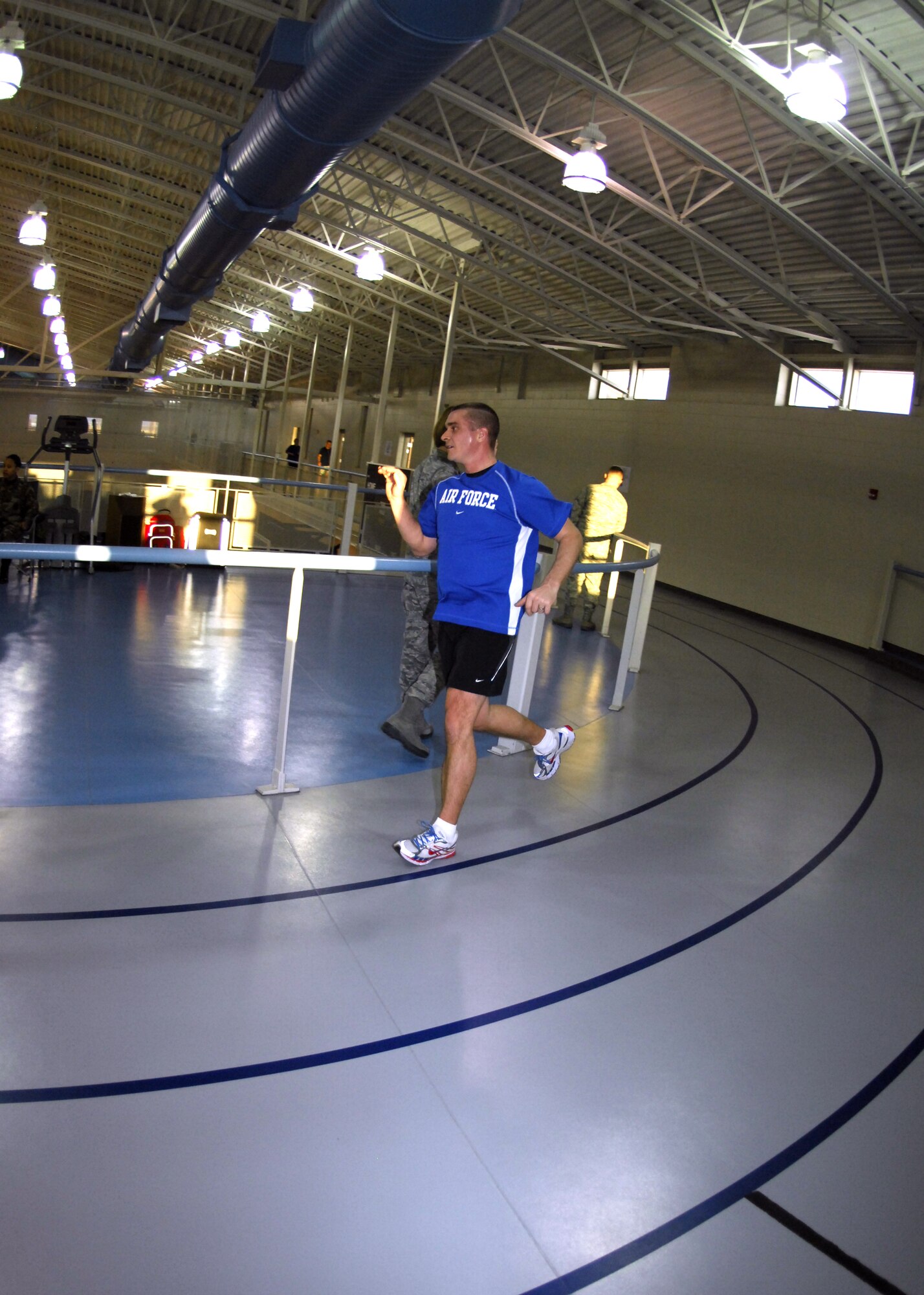 MINOT AIR FORCE BASE, N.D. -- Master Sgt. Thomas Raupach, 5th Maintenance Squadron Aerospace Ground Equipment production supervisor, finishes up the fourth mile of his 13.1 mile run here Dec. 31. Participants running in the marathon were expected to complete a total of 105 laps, which equaled 13.1 miles. (U.S. Air Force photo by Airman 1st Class Ashley N. Avecilla)