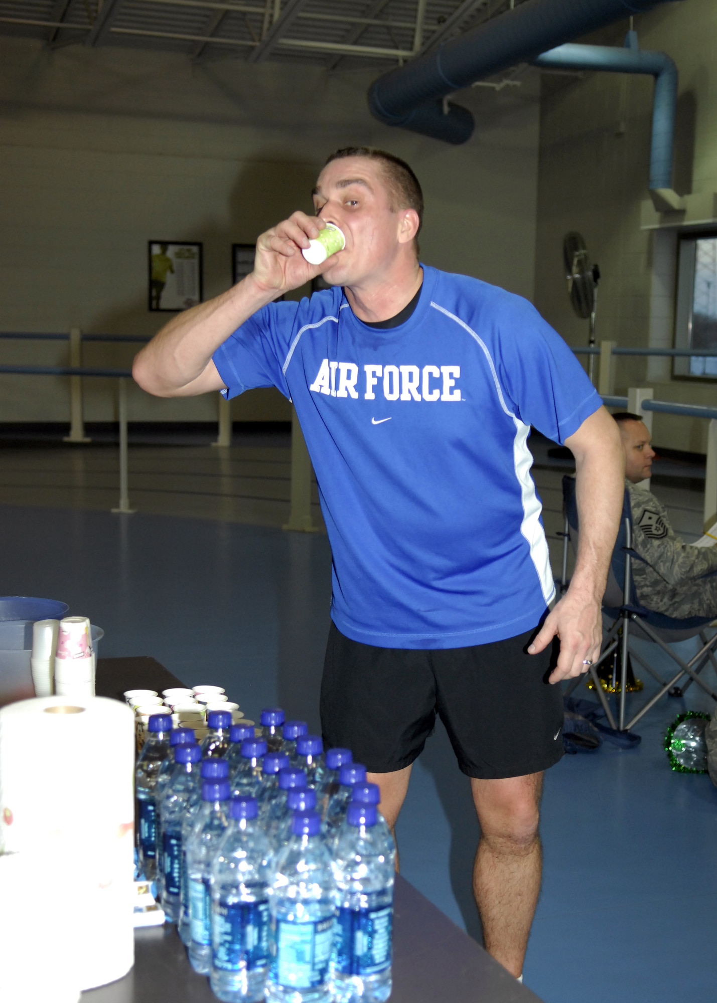 MINOT AIR FORCE BASE, N.D. -- Master Sgt. Thomas Raupach, 5th Maintenance Squadron Aerospace Ground Equipment production supervisor, stops for a drink of water during the New Years Eve Half Marathon at the McAdoo Fitness Center here Dec. 31. Sergeant Raupach not only ran in the half marathon but also was in charge of putting the event together. (U.S. Air Force photo by Airman 1st Class Ashley N. Avecilla)